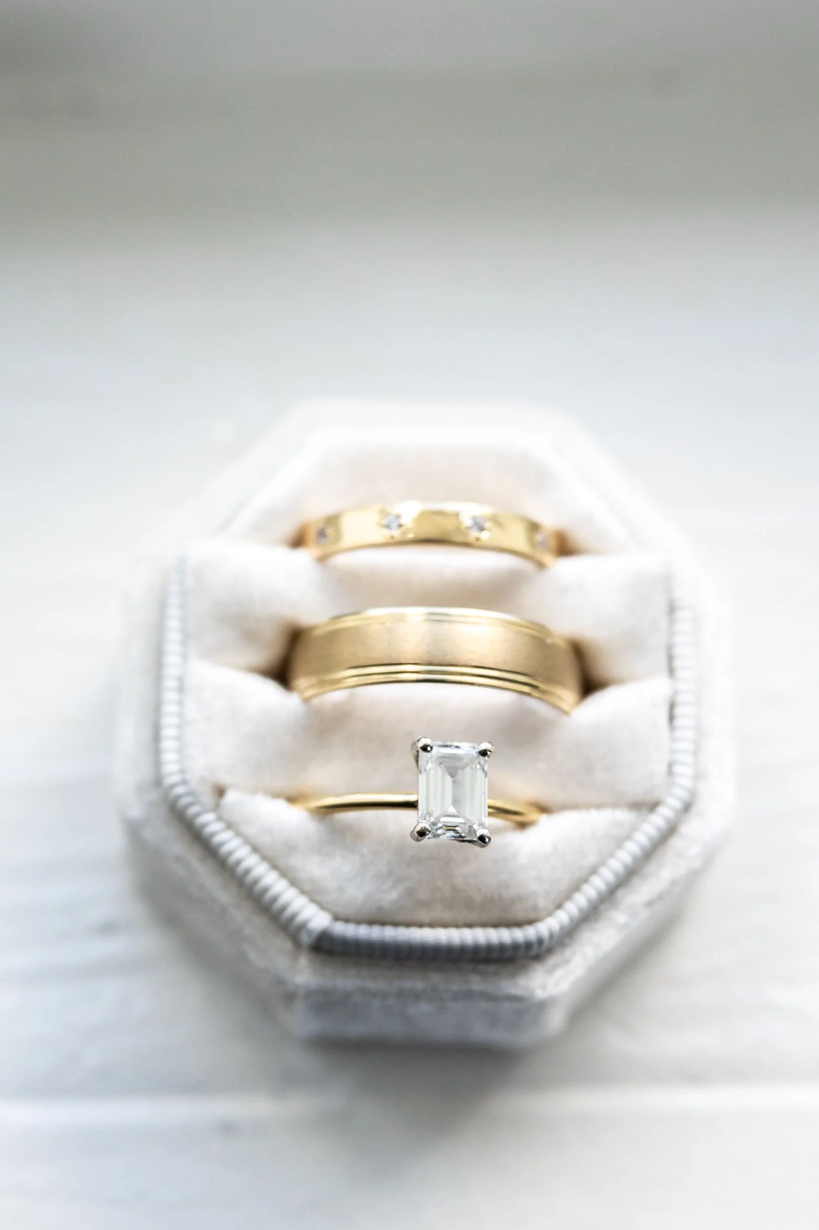 three-gold-rings-with-diamonds-displayed-in-a-hexagonal-velv.jpg