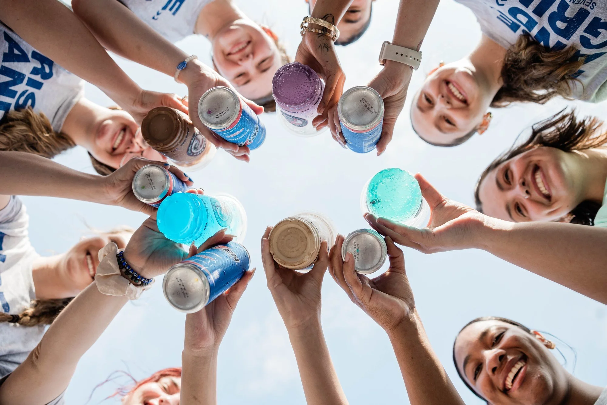 people-holding-colorful-drinks-in-a-circle-while-smiling-and.jpg