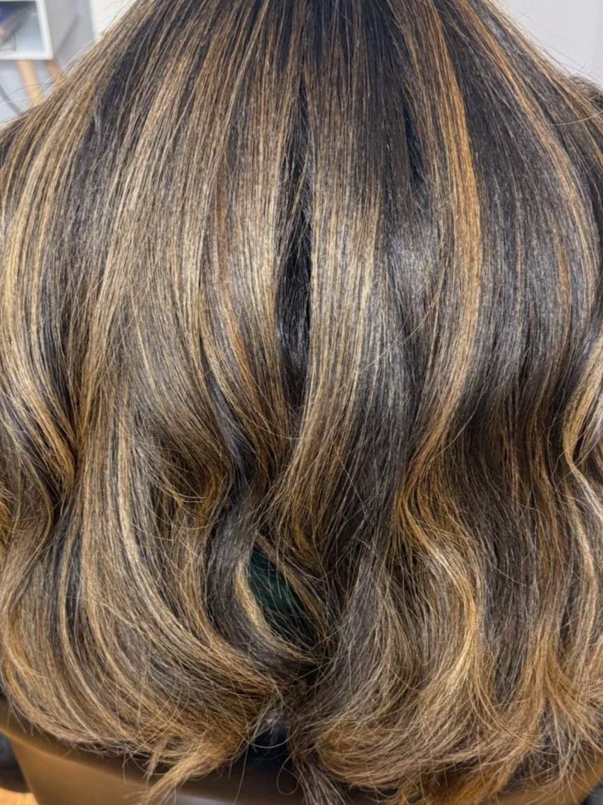 Close-up of wavy, multi-toned brown hair.