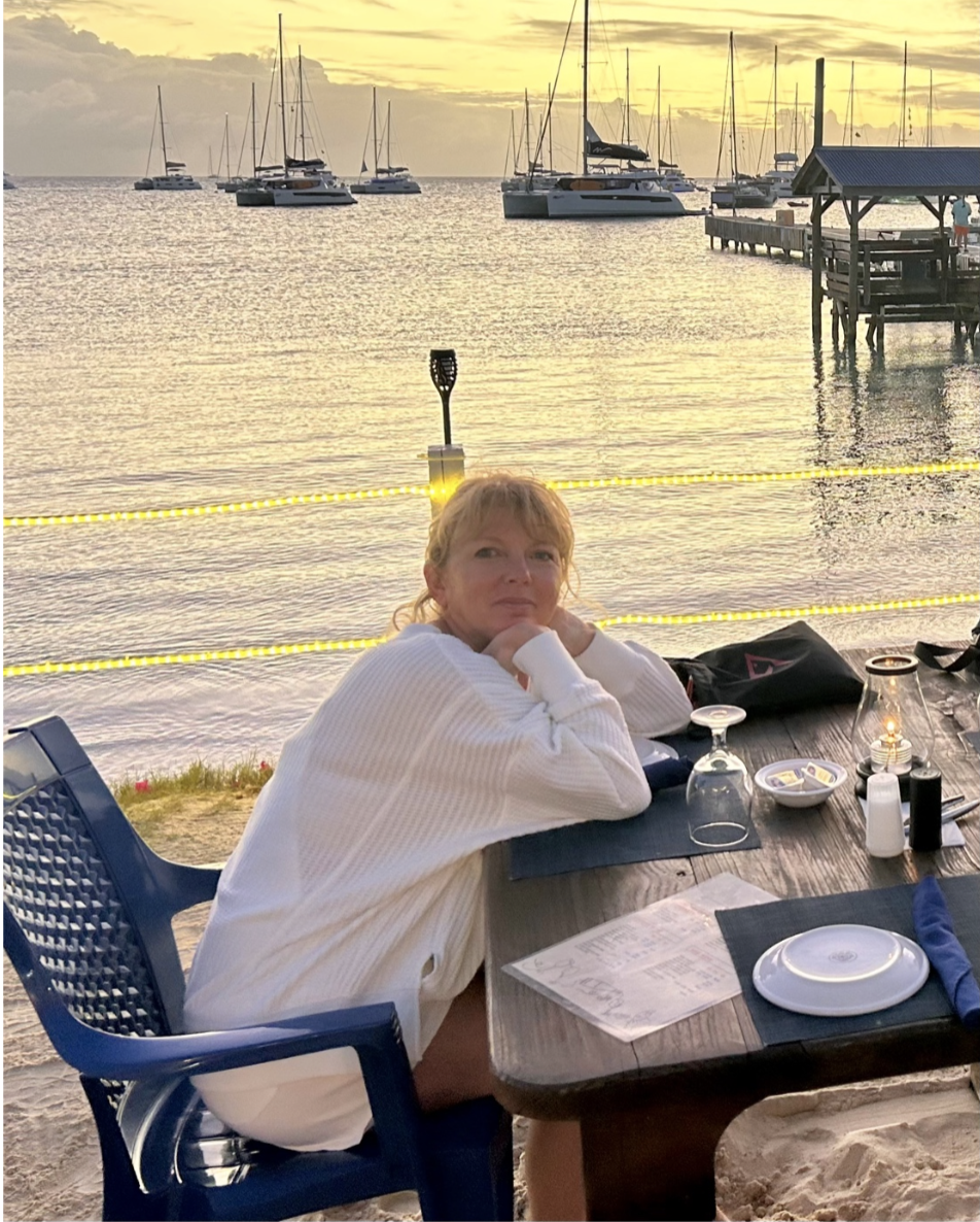 woman enjoying meal on beach at sunset