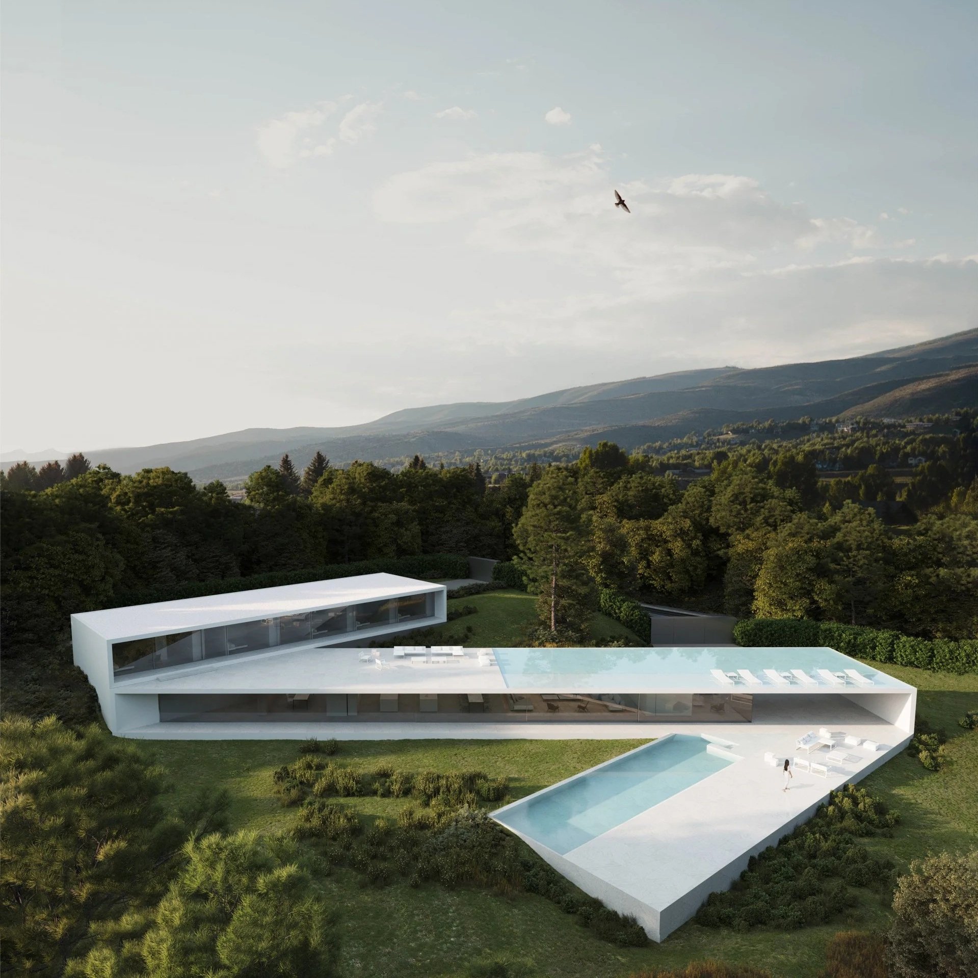 Modern architectural white house with an irregular shape, featuring multiple levels with large glass windows, a pool area with lounge chairs, and surrounded by lush green trees and hills.