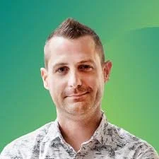 Man with short hair and patterned shirt against a green gradient background