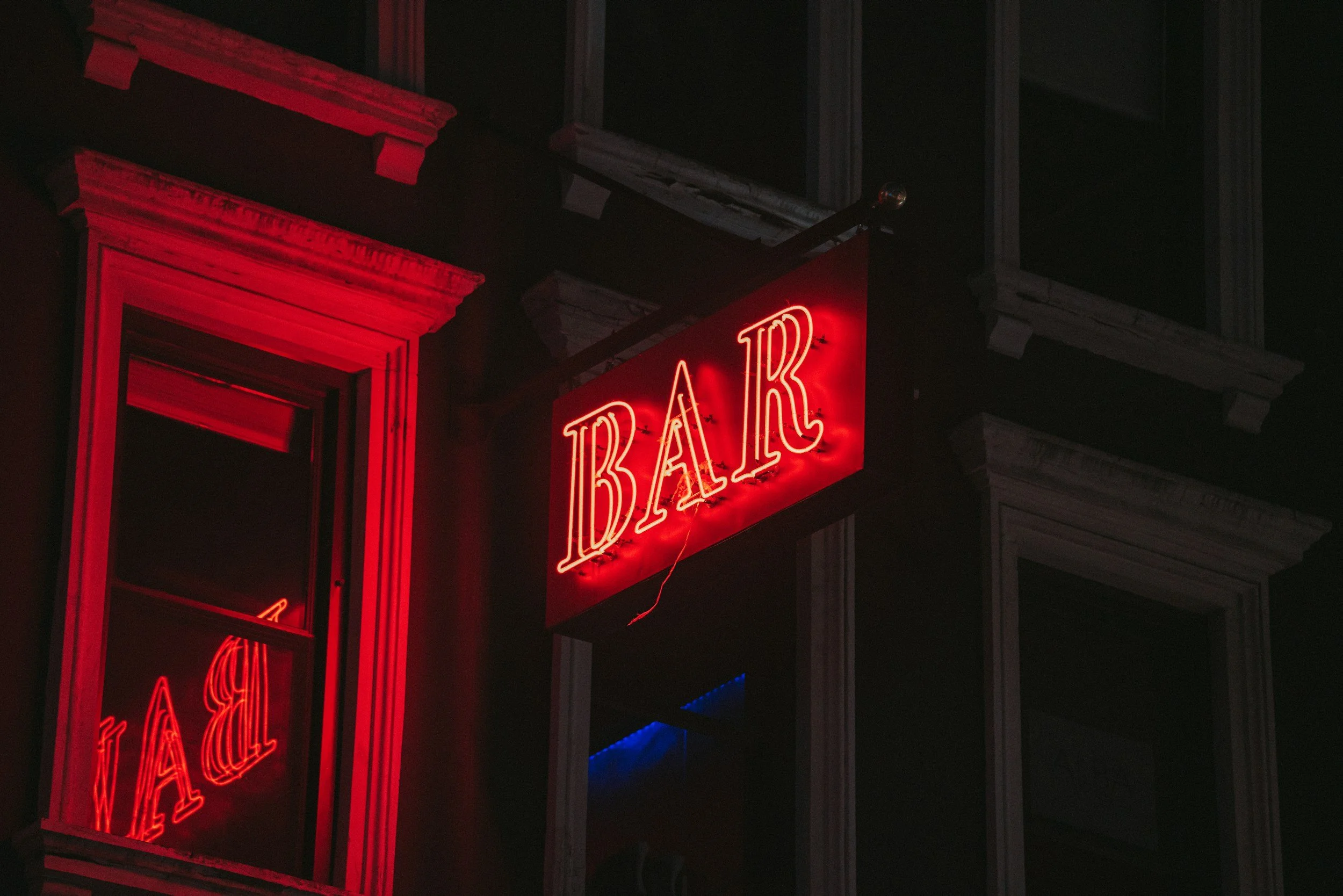 empty bar exterior at night neon sign