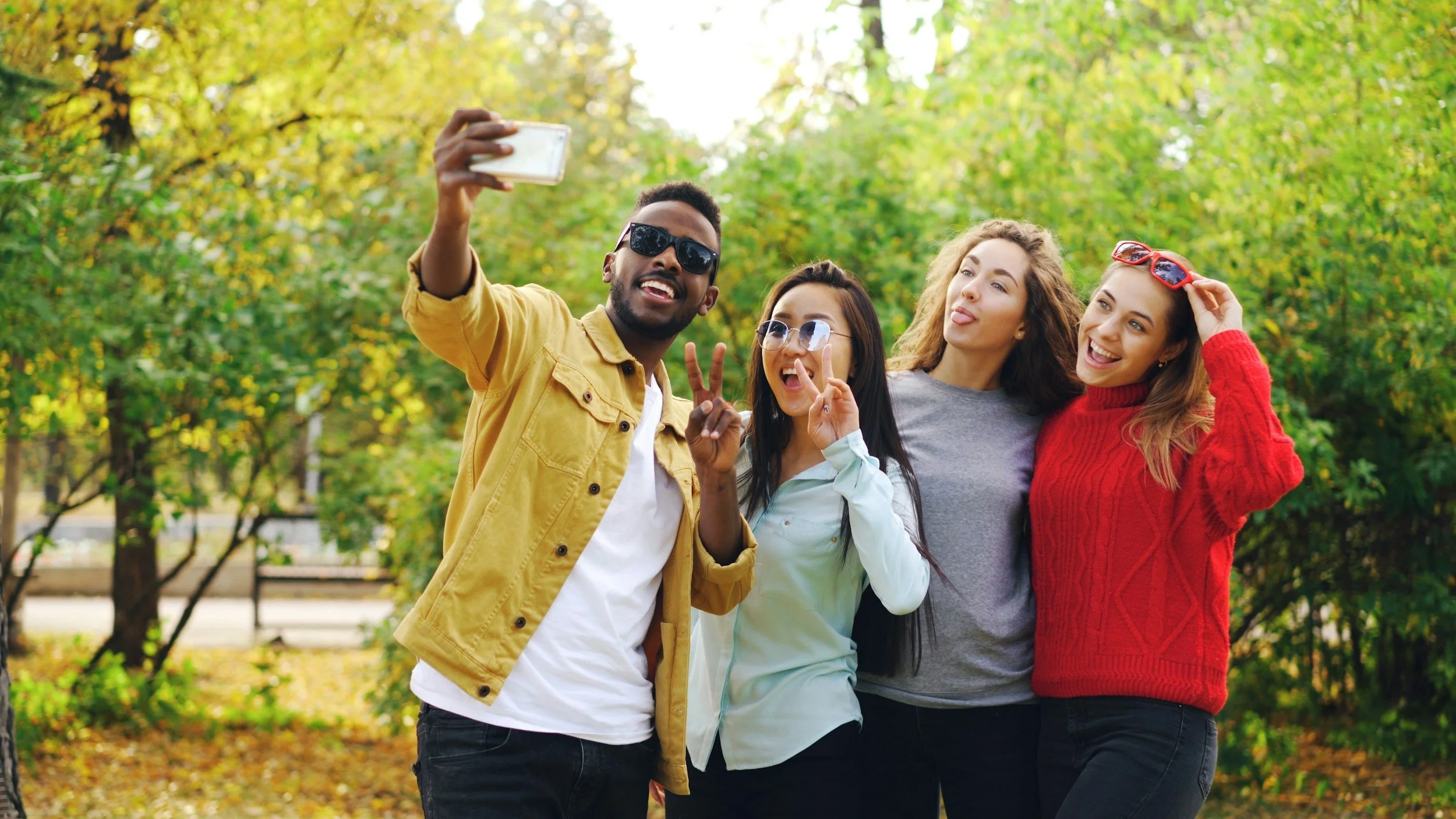 Friends taking a group photo, the kind of tagged post that can affect an injury claim.