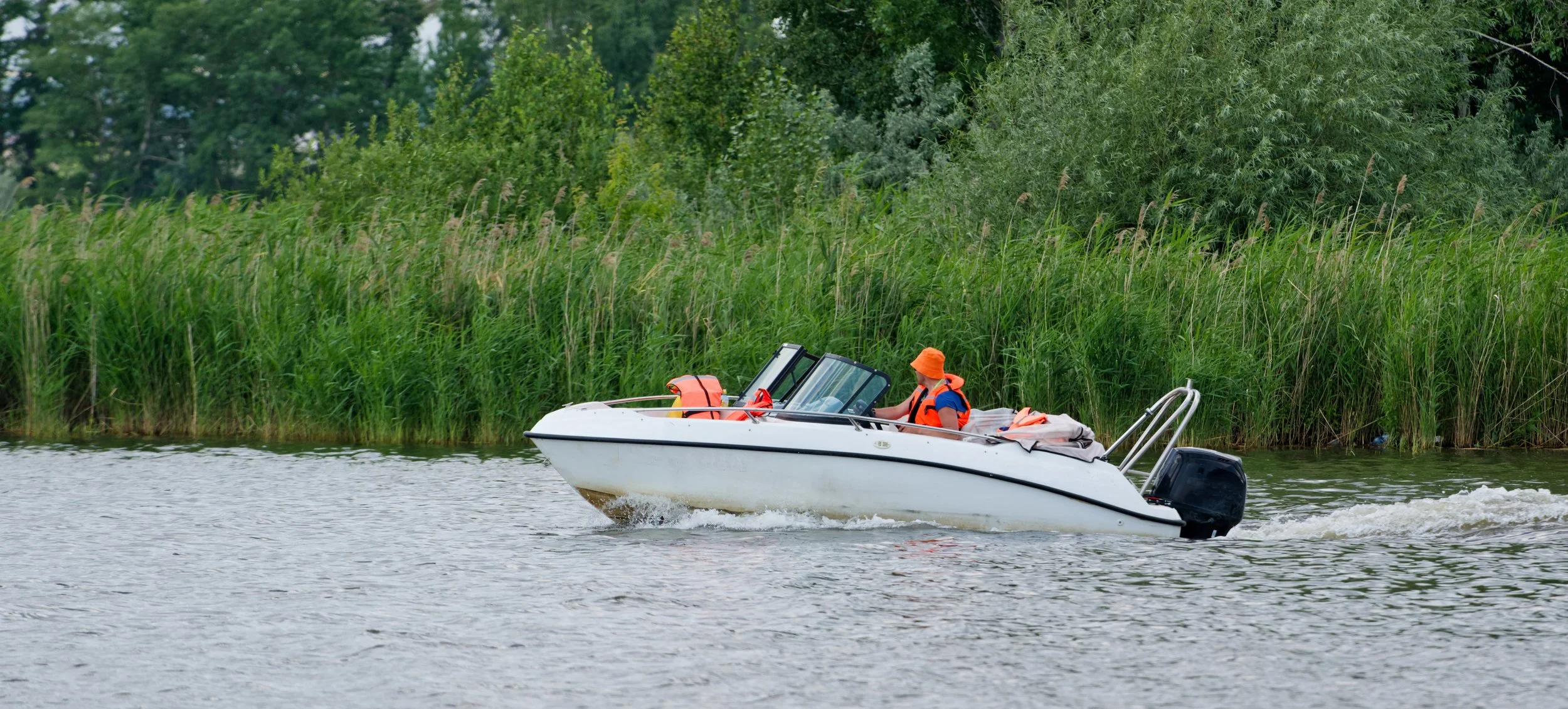 Boater operating a motorboat on a Pennsylvania lake during summer