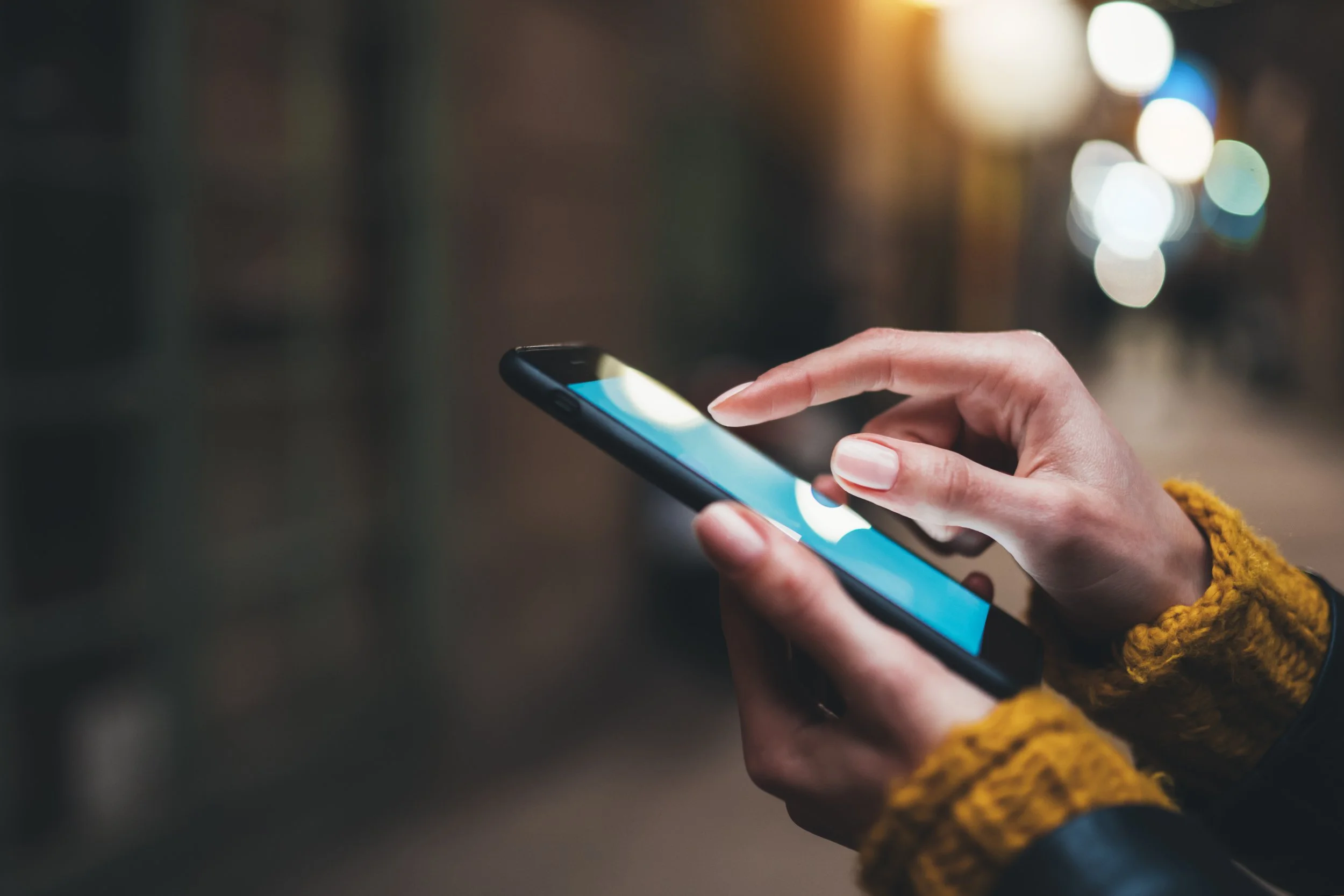 Person holding a smartphone open to social media apps
