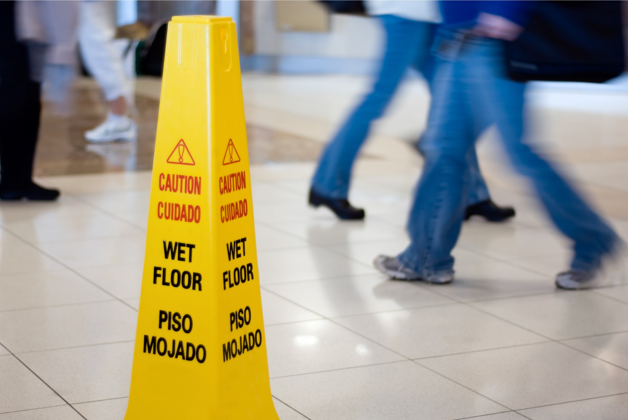 Customer photographing a floor hazard with a phone before leaving the property.