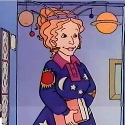 Ms. Frizzle, cartoon fashion icon of the 90s, wears a solar system diorama as the crowning glory to her solar system print dress.