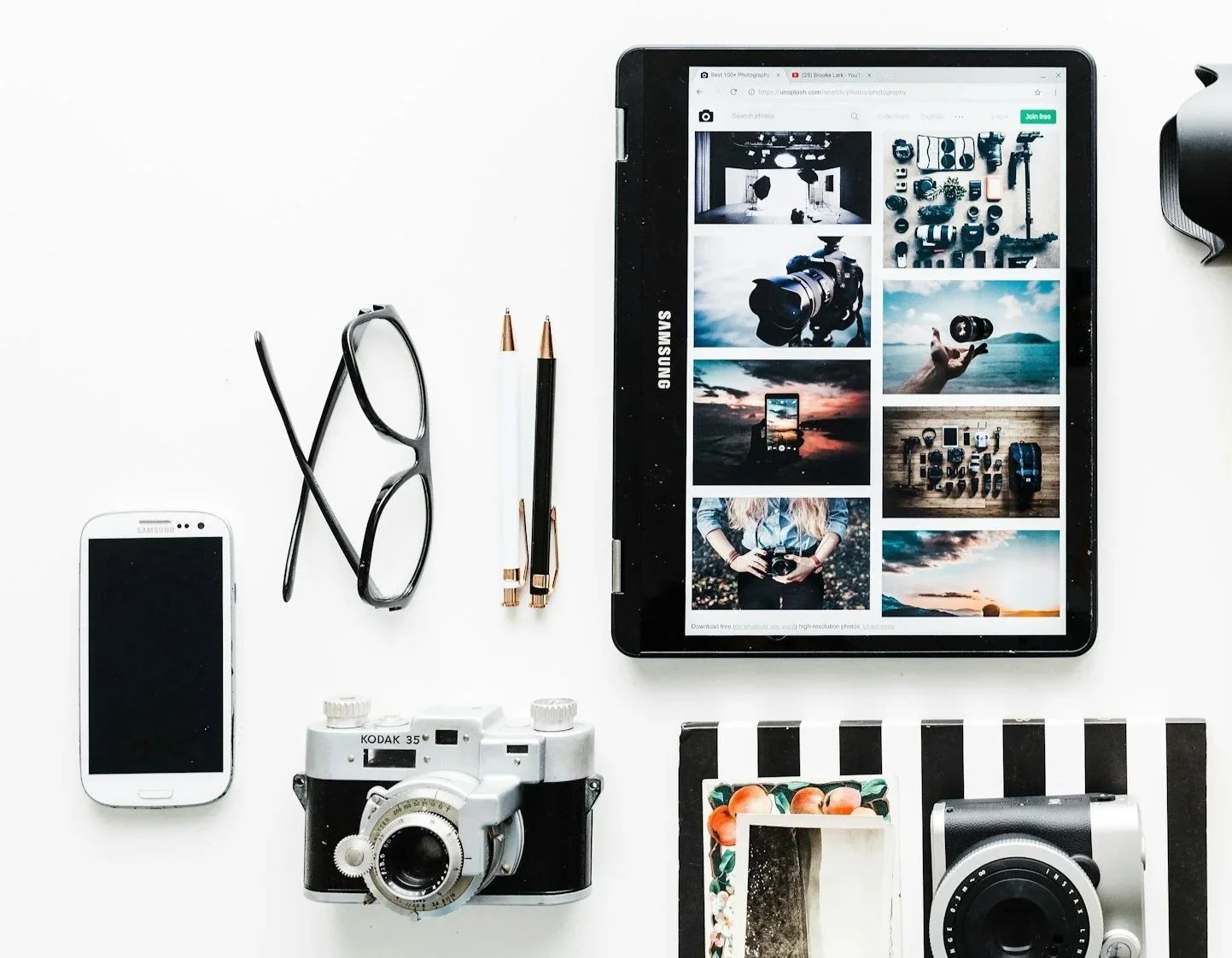 Camera equipment, tablet, and creative tools representing photographers, designers, and creative professionals