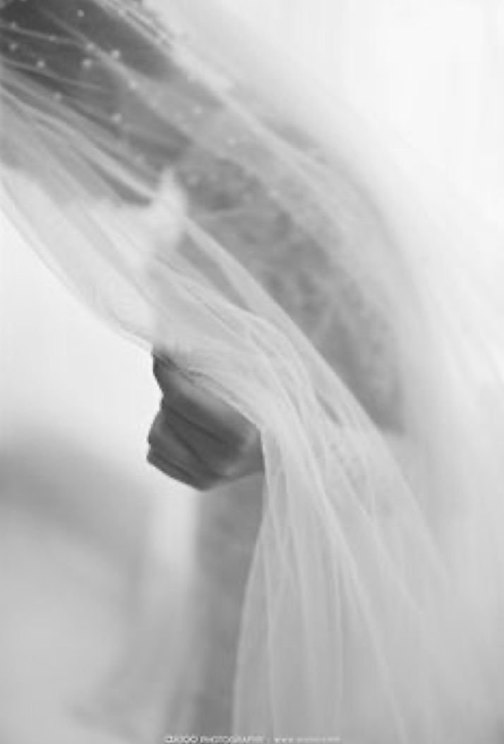 A close-up of white plastic bags hanging from a hook or handle.