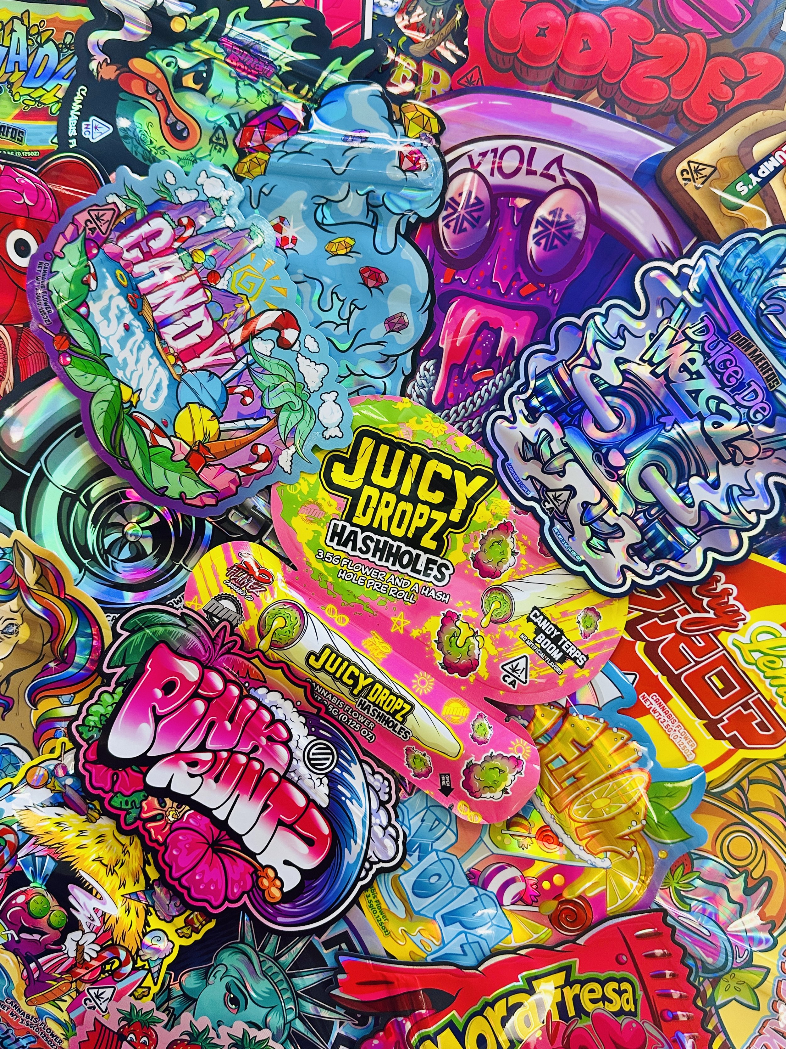 Assorted custom direct print mylar 8th bags featuring colorful branding, die-cut shapes, and illustrated packaging artwork created for product packaging.