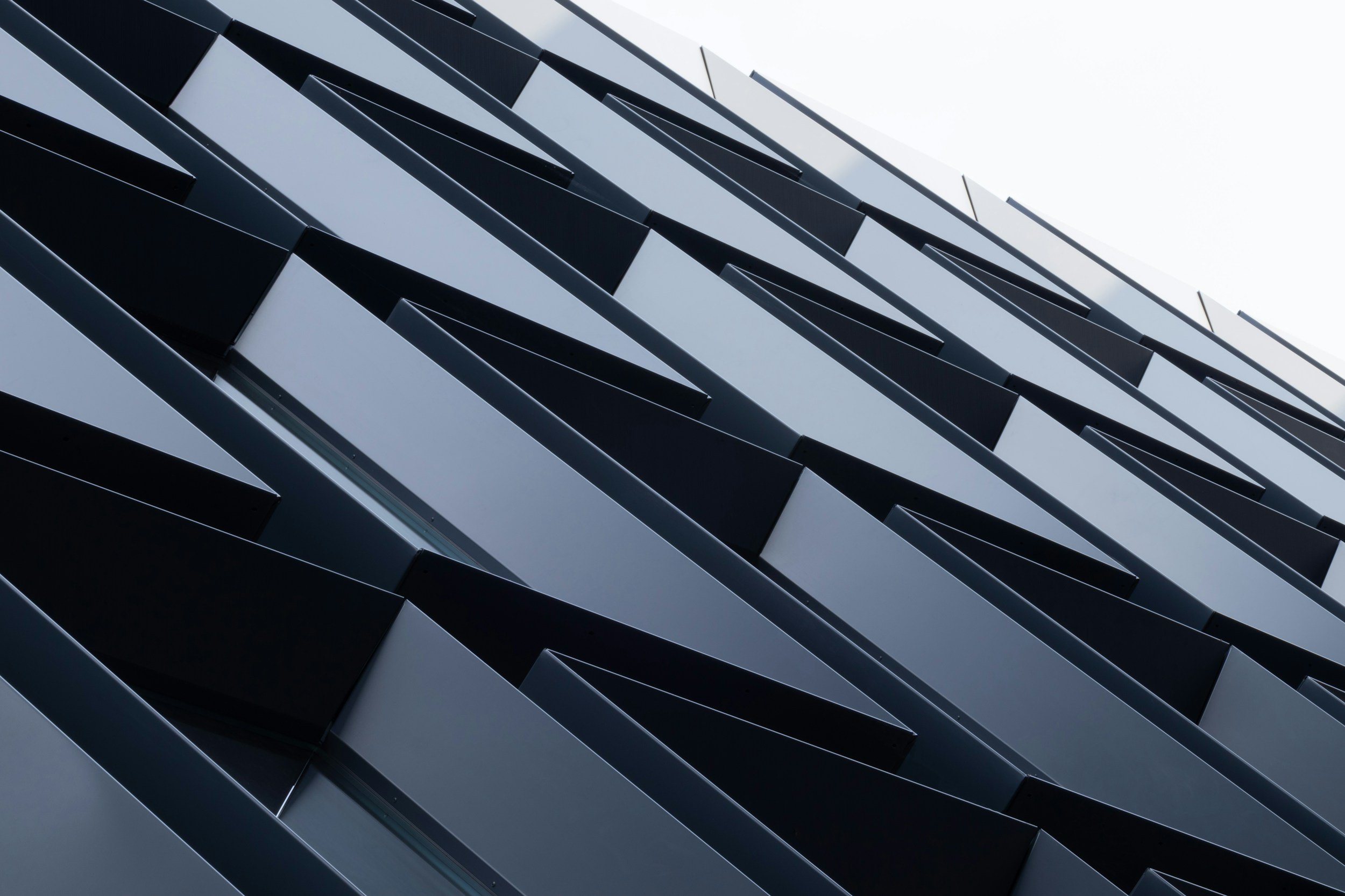 Close-up of a modern building facade with black and white angular, layered panels.