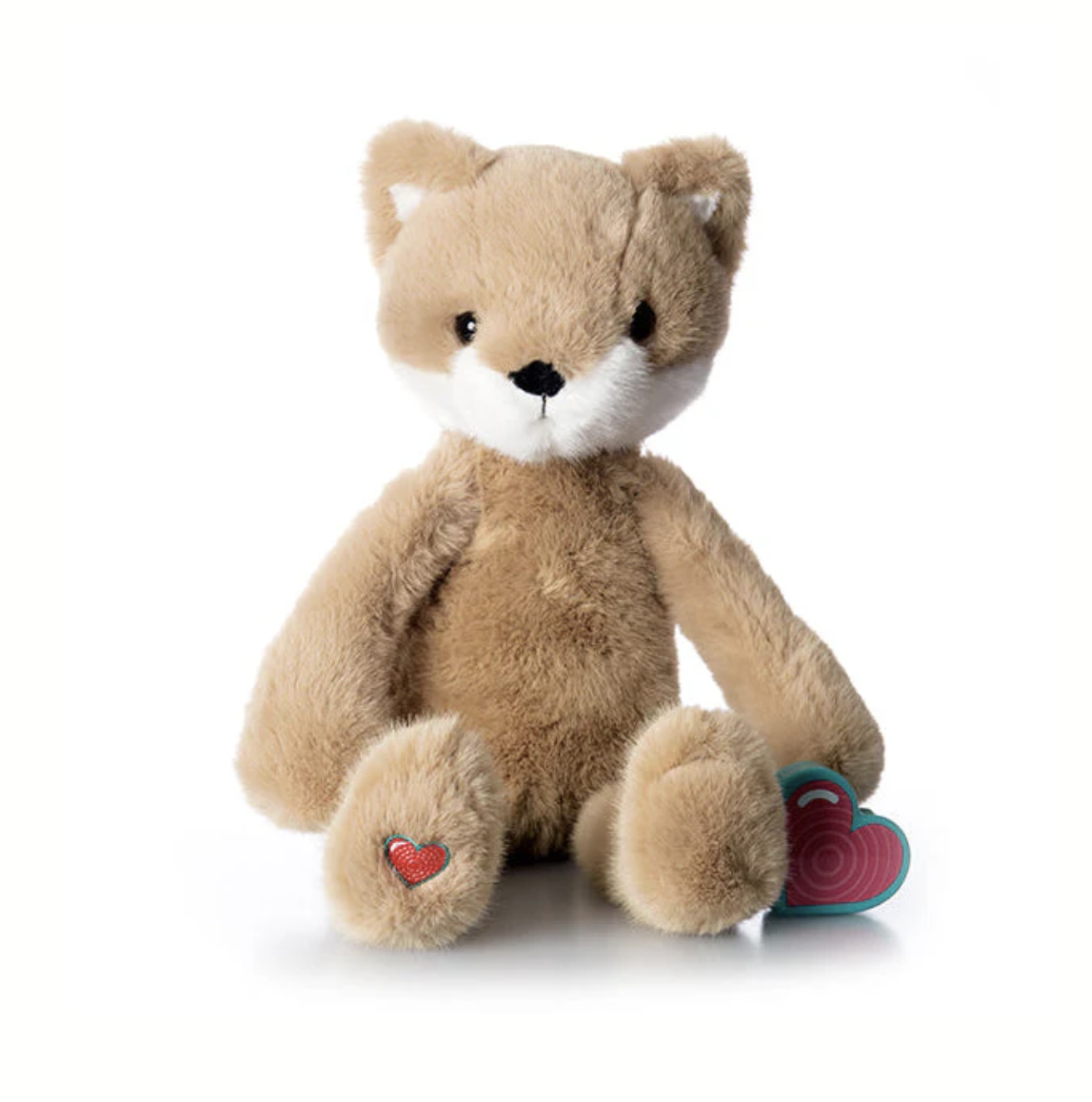 A tan plush teddy bear with a white snout, black eyes, and a stitched nose, sitting on a white background with a red heart on its left paw and a heart-shaped object on the right.