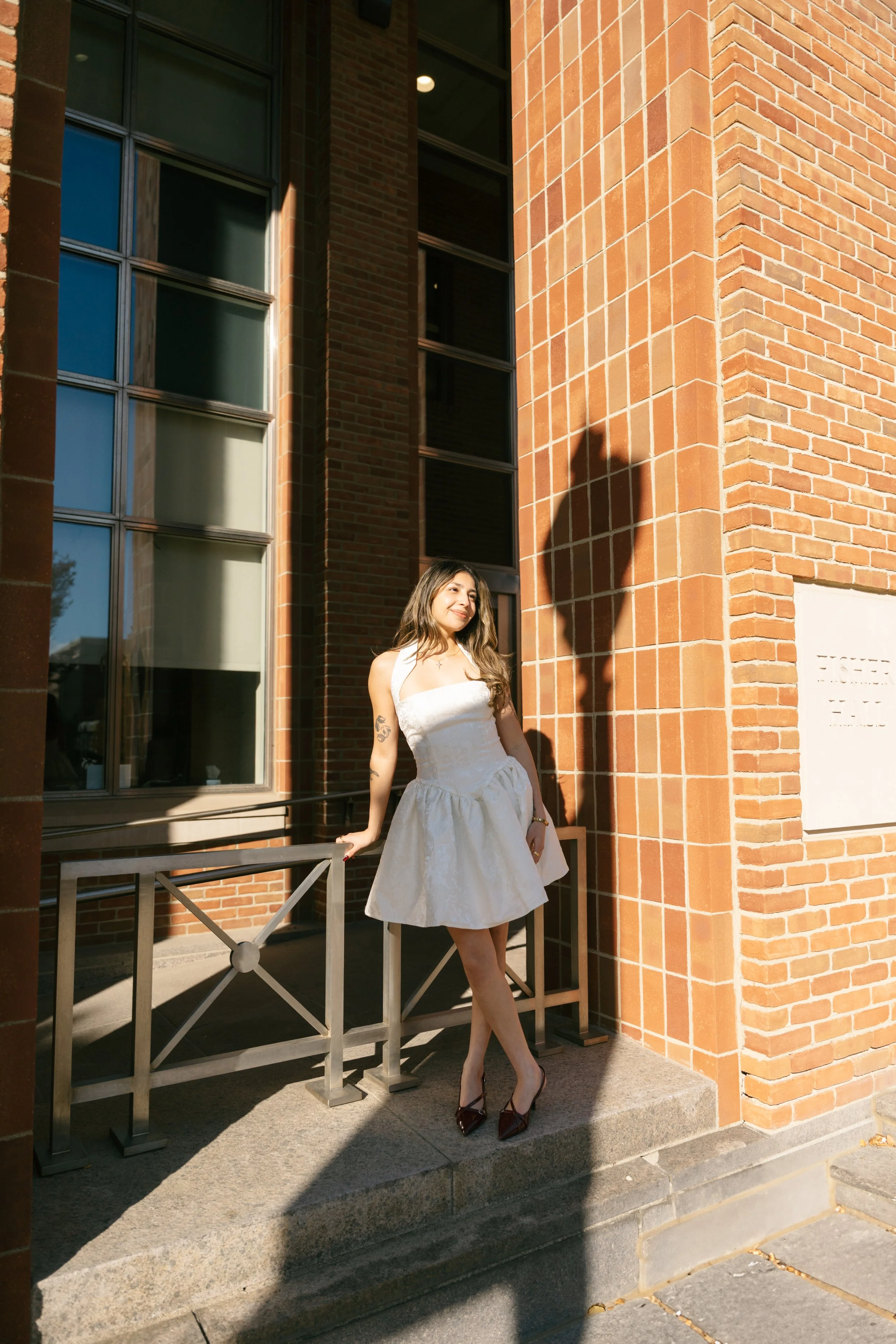 OSU senior photo of a college graduate smiling while looking radiant in the golden hour glow for timeless and candid senior photos