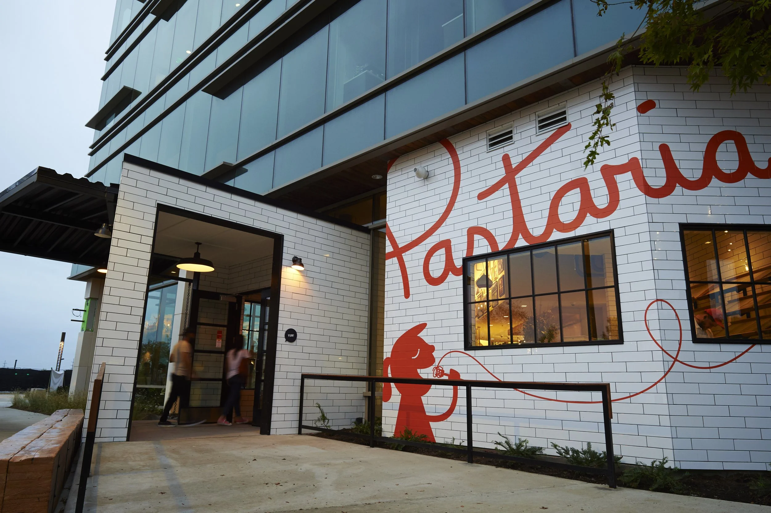 Exterior of Pastaria Nashville with tiled walls, red mural artwork, and entrance ramp.