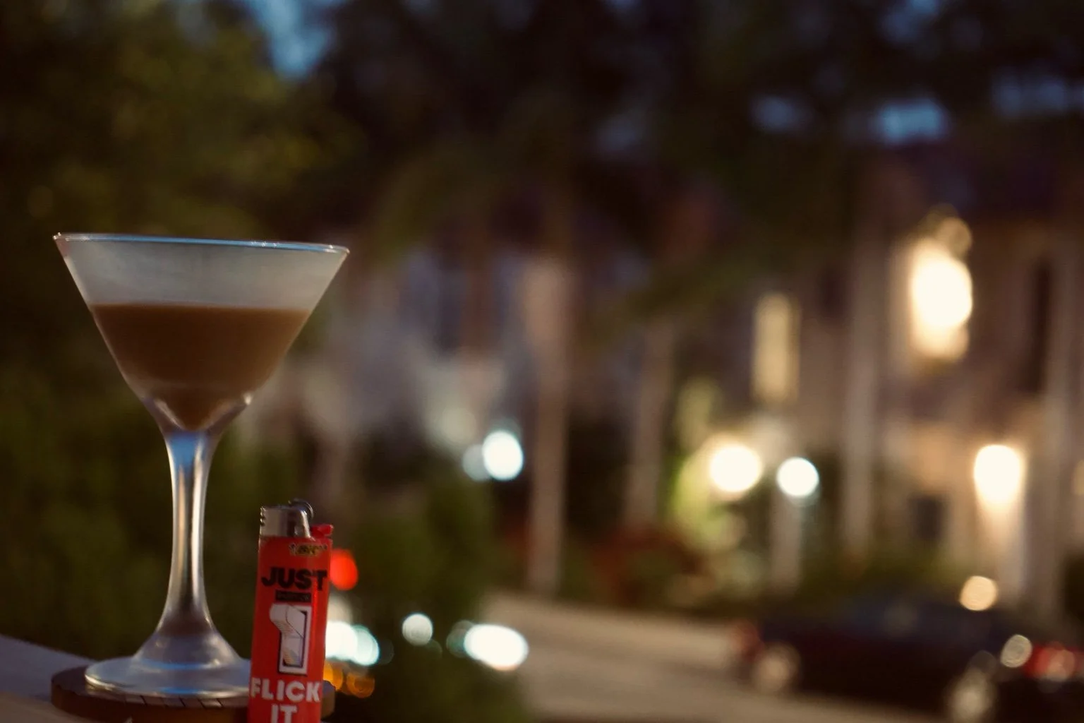 Half-full glass. Half-lit lighter. The night hasn’t decided who she wants to be yet — and neither have I