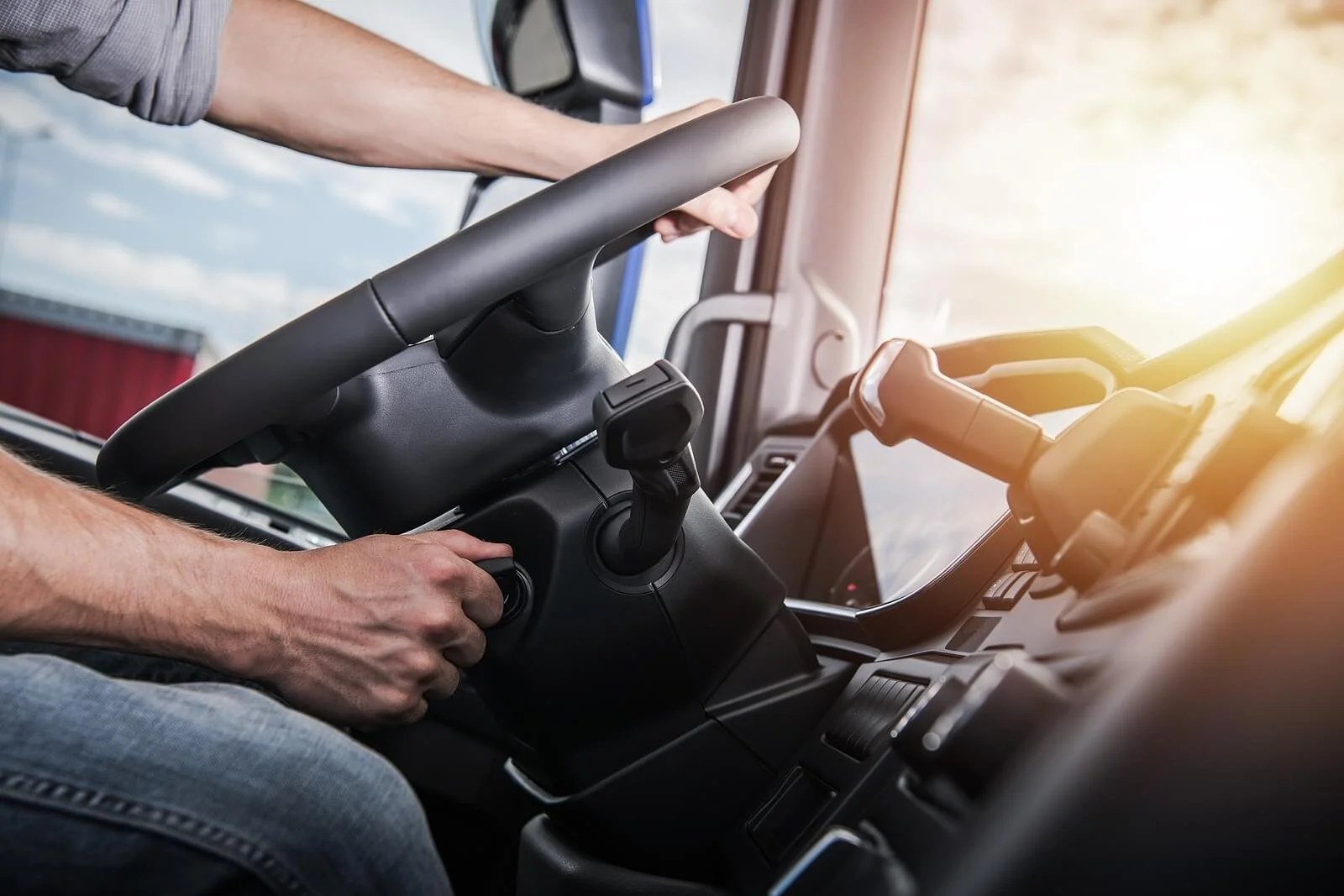 Truck driver’s hands holding the steering wheel inside a modern commercial vehicle cab. Take the next step toward returning to safety-sensitive work with SAP evaluations in New Mexico designed to support compliance and peace of mind.