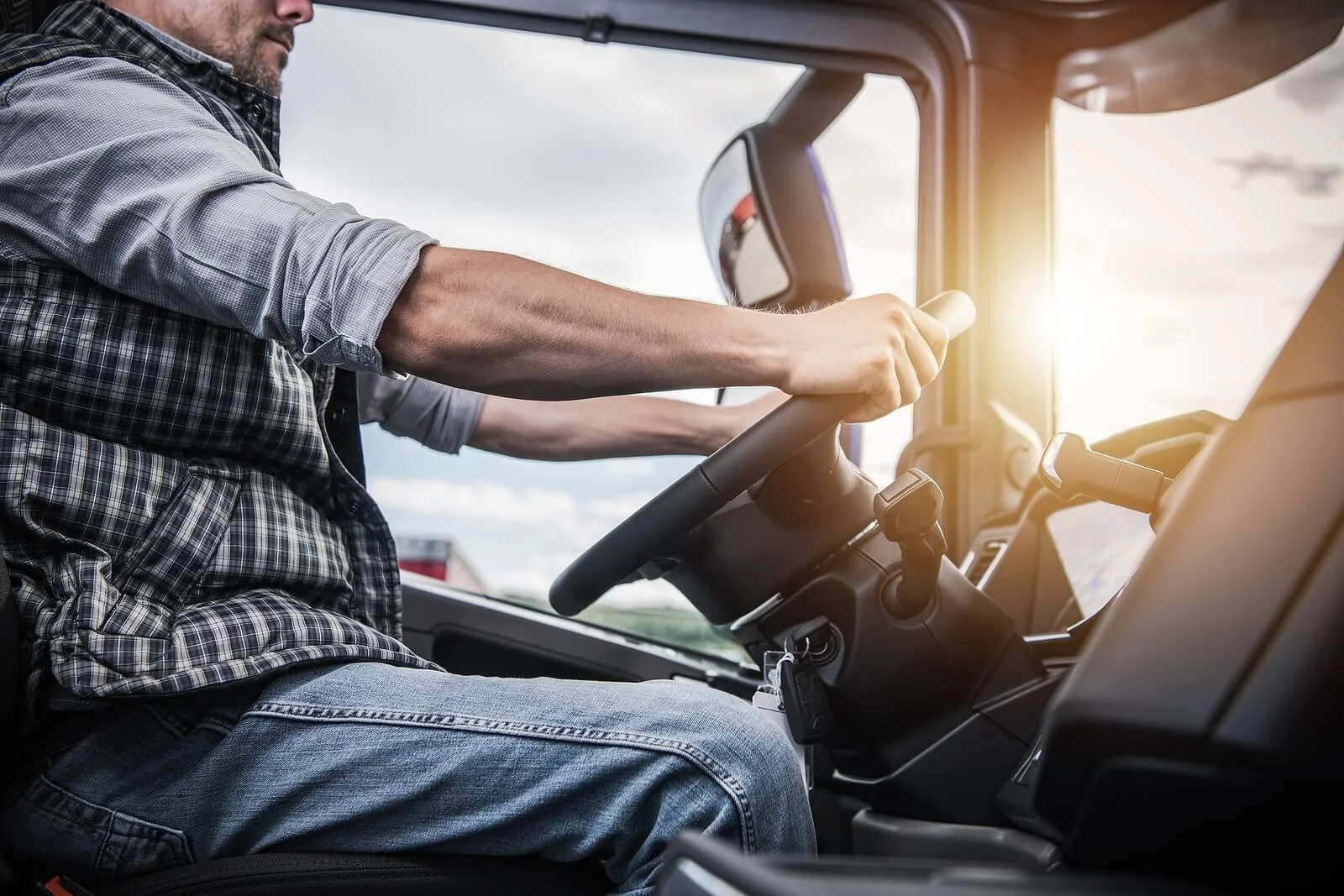 Truck driver holding steering wheel with steady focus. SAP evaluations in New Mexico provide drivers with structured support from a substance abuse professional to help them safely and confidently return to the road.