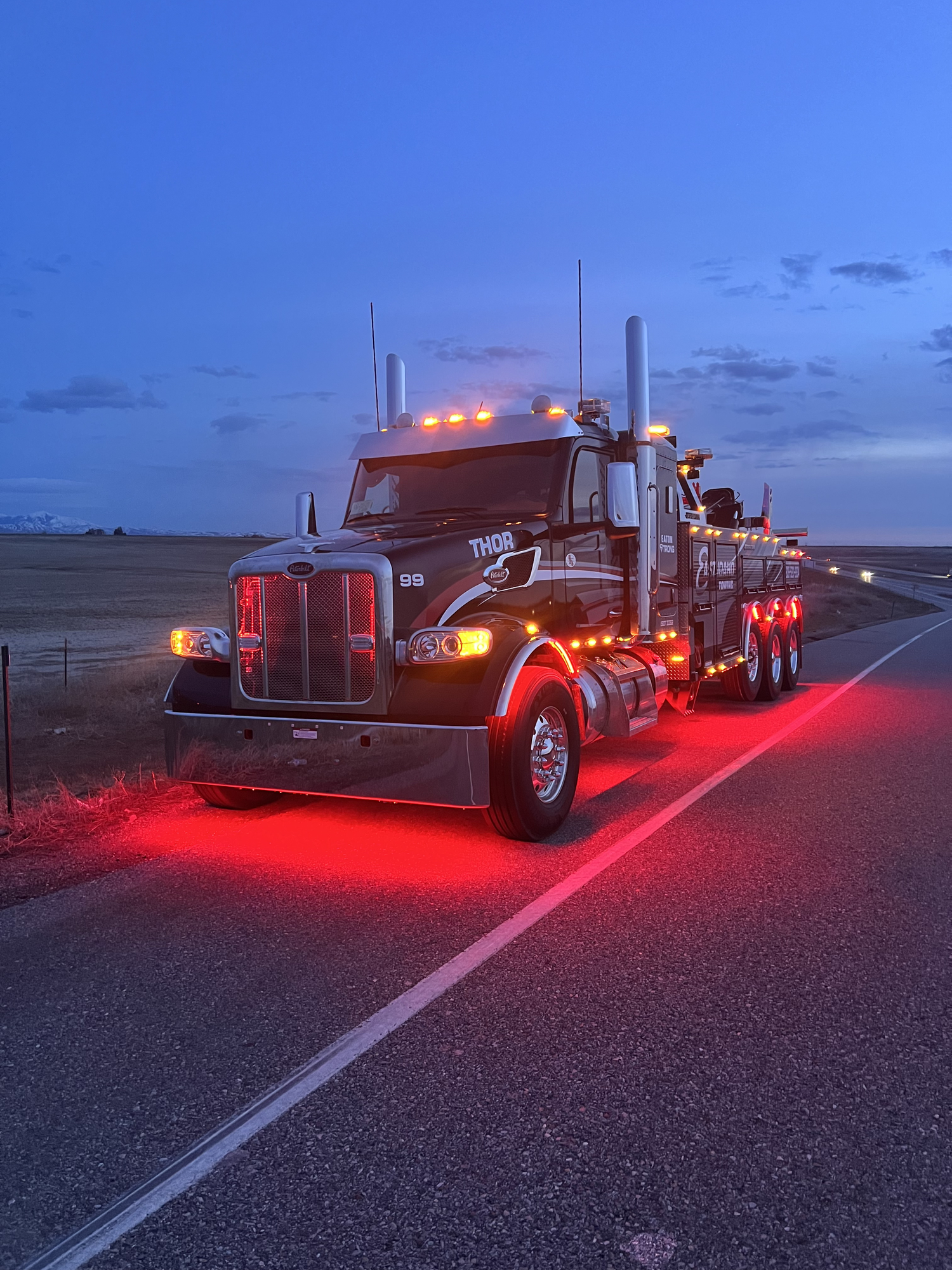 Eaton Road Solutions heavy-duty wrecker responding at dusk