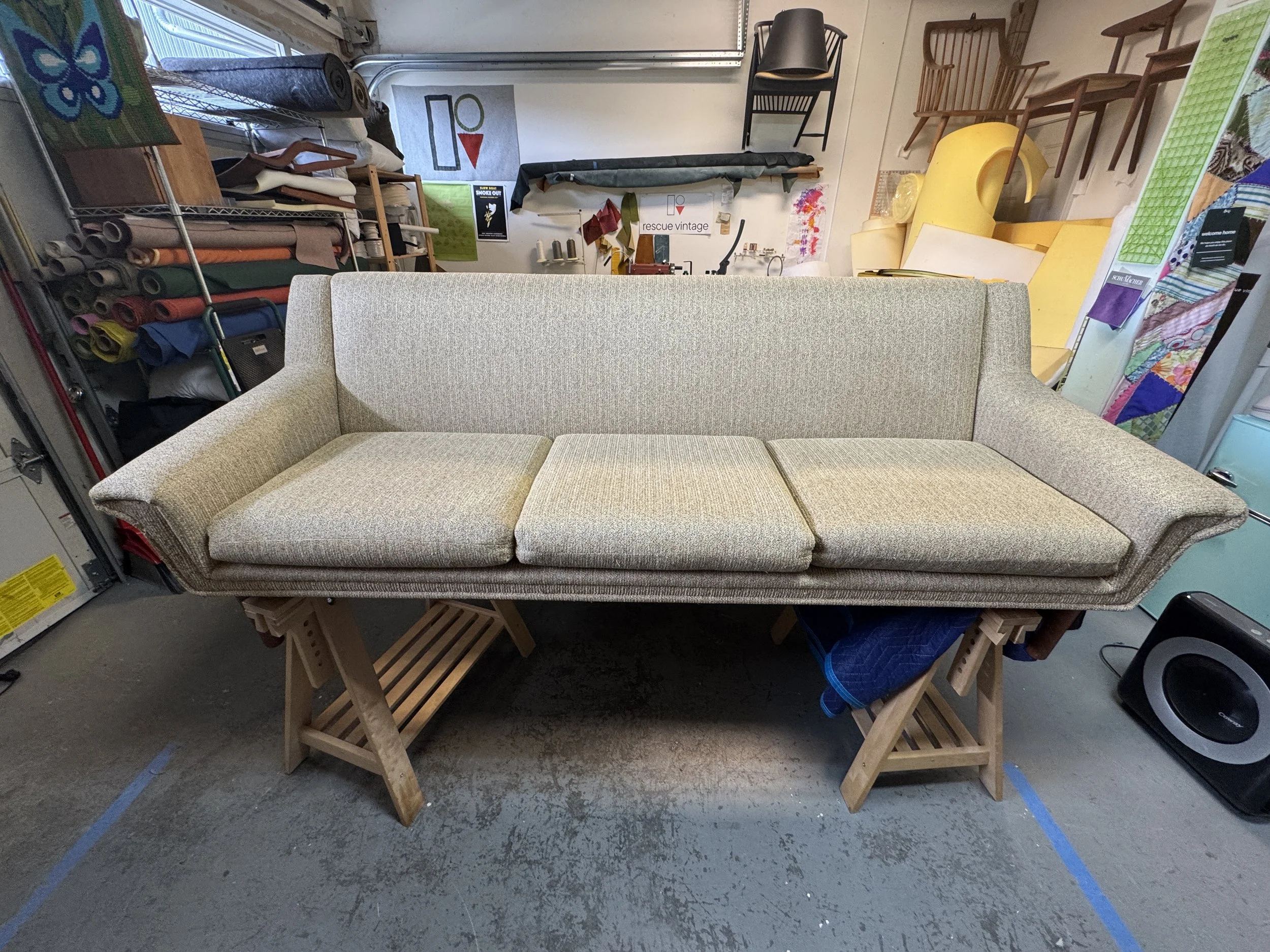 Vintage Danish modern sofa before reupholstery, showing its original upholstery and condition prior to restoration.