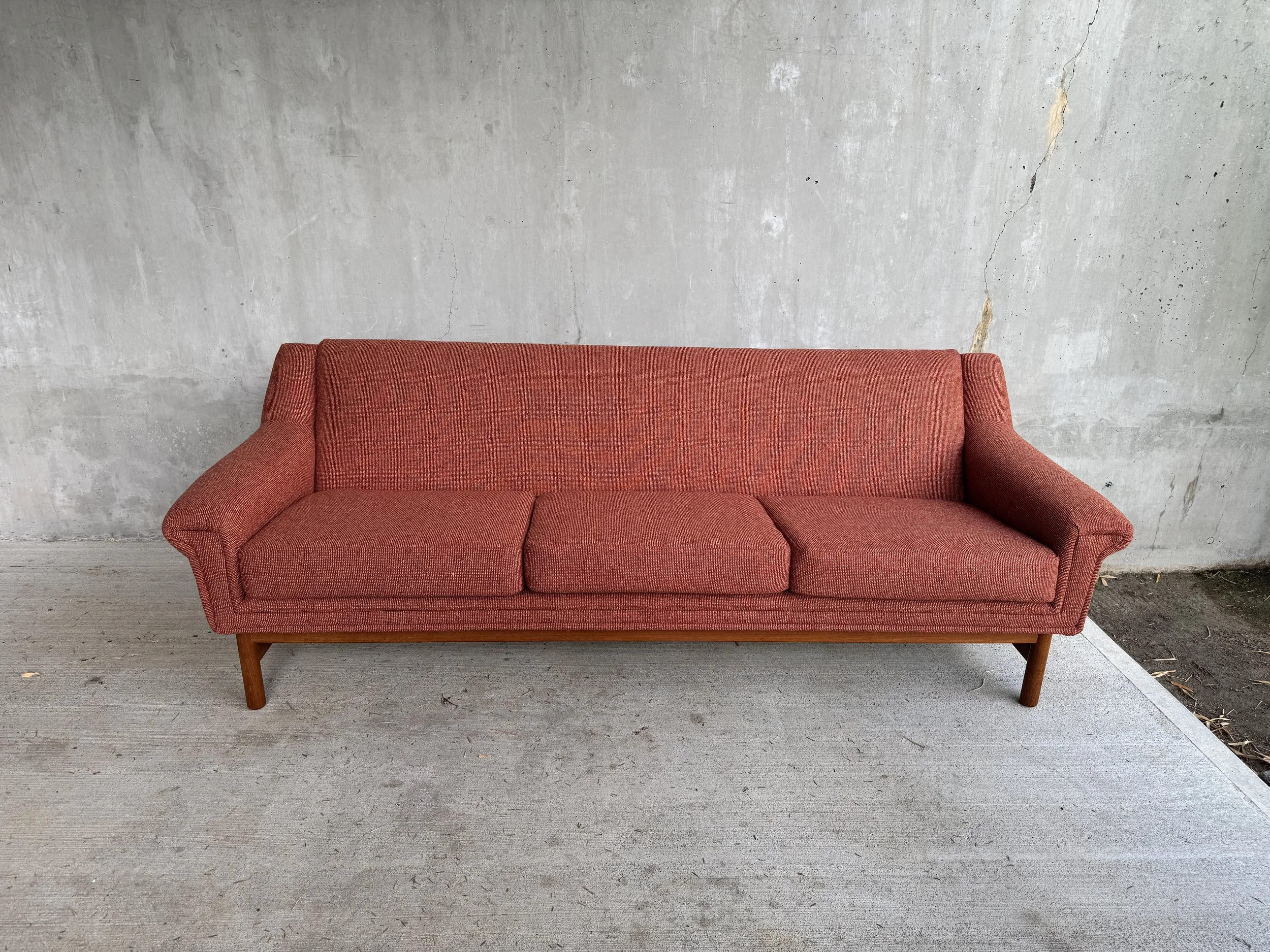 Restored Danish modern sofa upholstered in rust-colored Luum Wool Fleck, photographed after reupholstery.