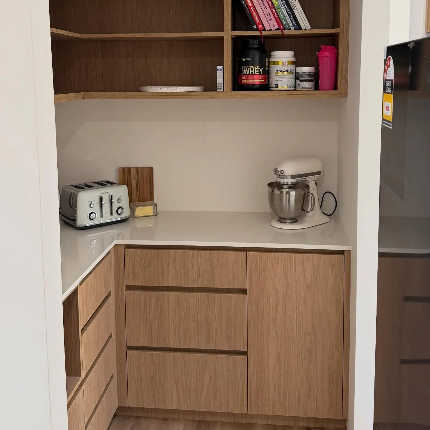 This pantry was also designed for our valued clients in Eglinton, bringing functionality to an often-overlooked space

- Boston Oak Vertical Grain
- Finger Pull handles 
- 20mm Evostone Bench top
- Open shelving with functional corner cabinet
- Blum 