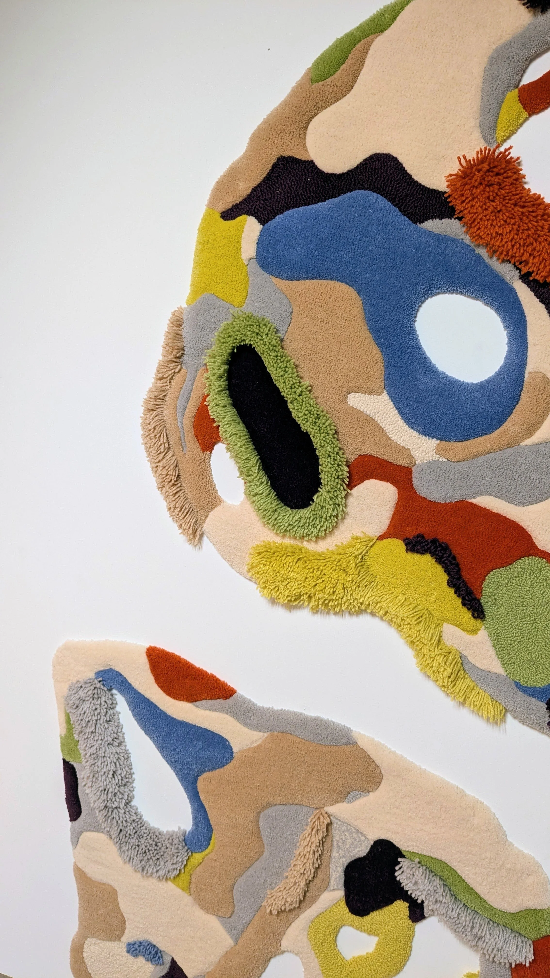 Colorful abstract tufted textile art  in various colors and textures.