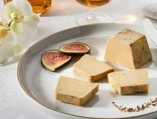 high quality french pate de fois and sliced figs on a white plate