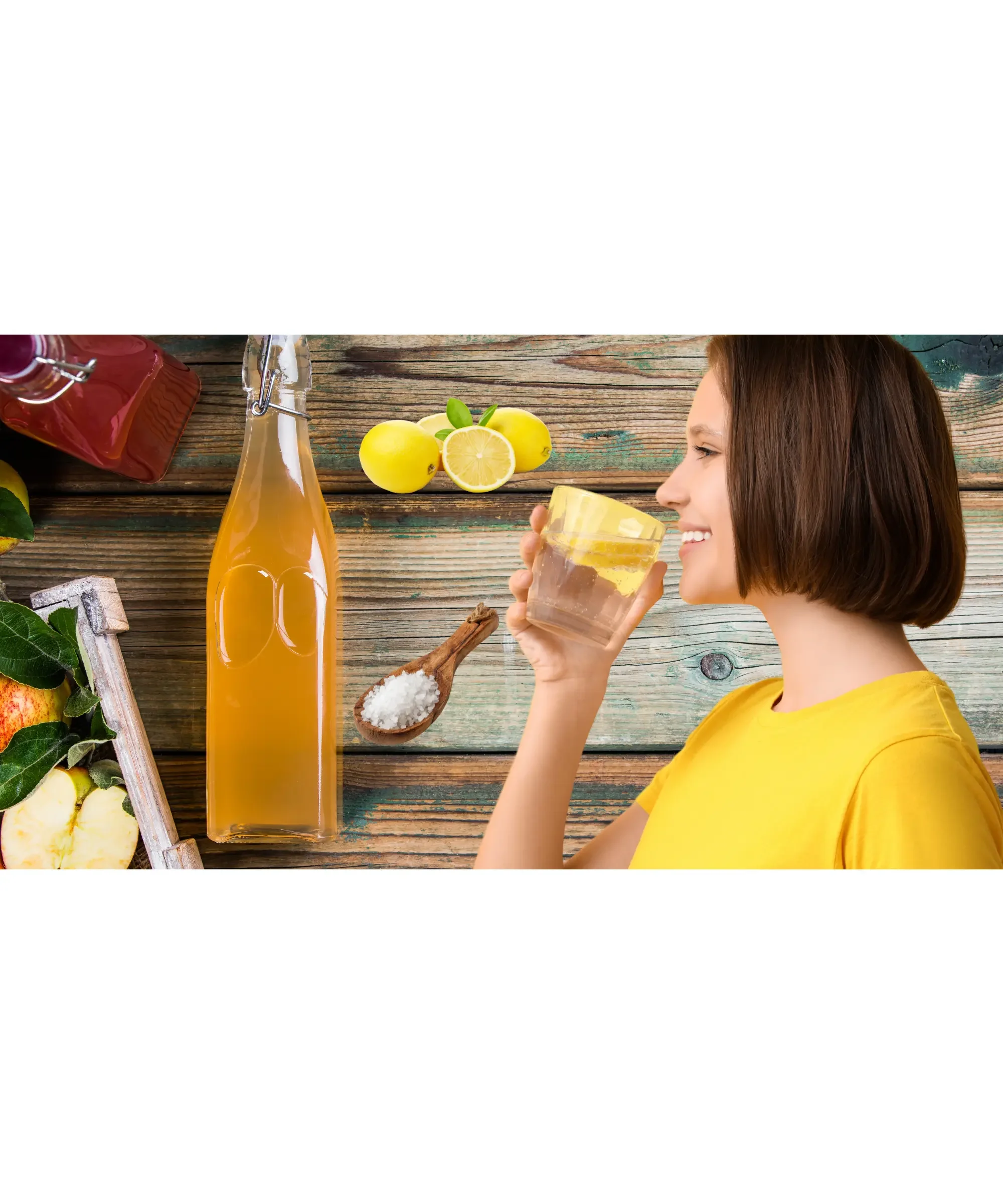 Woman drinking lemon water with apple cider vinegar, fresh lemons, apples and sea salt on rustic wooden table, natural detox and hydration wellness concept