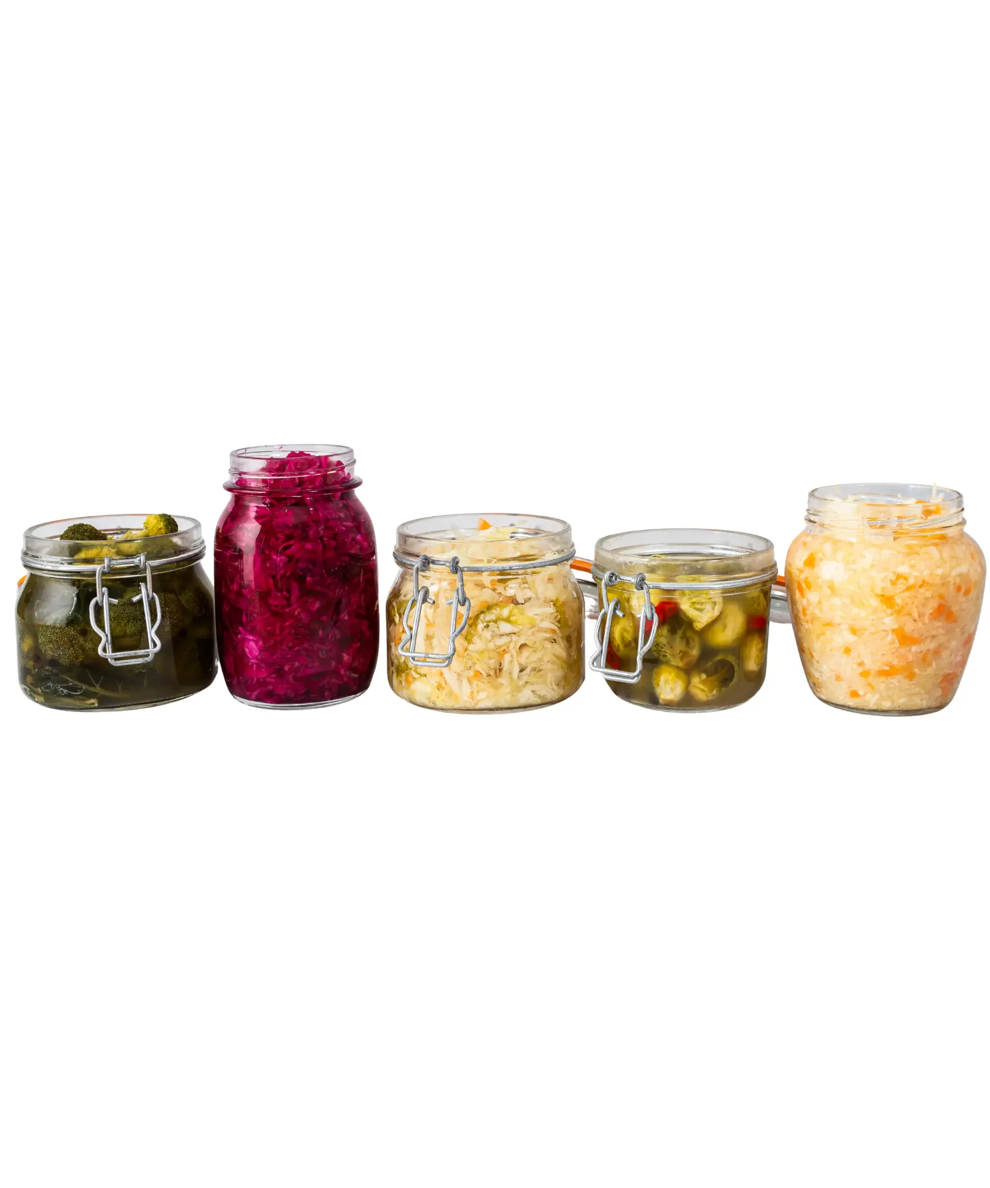 Glass jars filled with fermented vegetables including pickles, sauerkraut, and cabbage