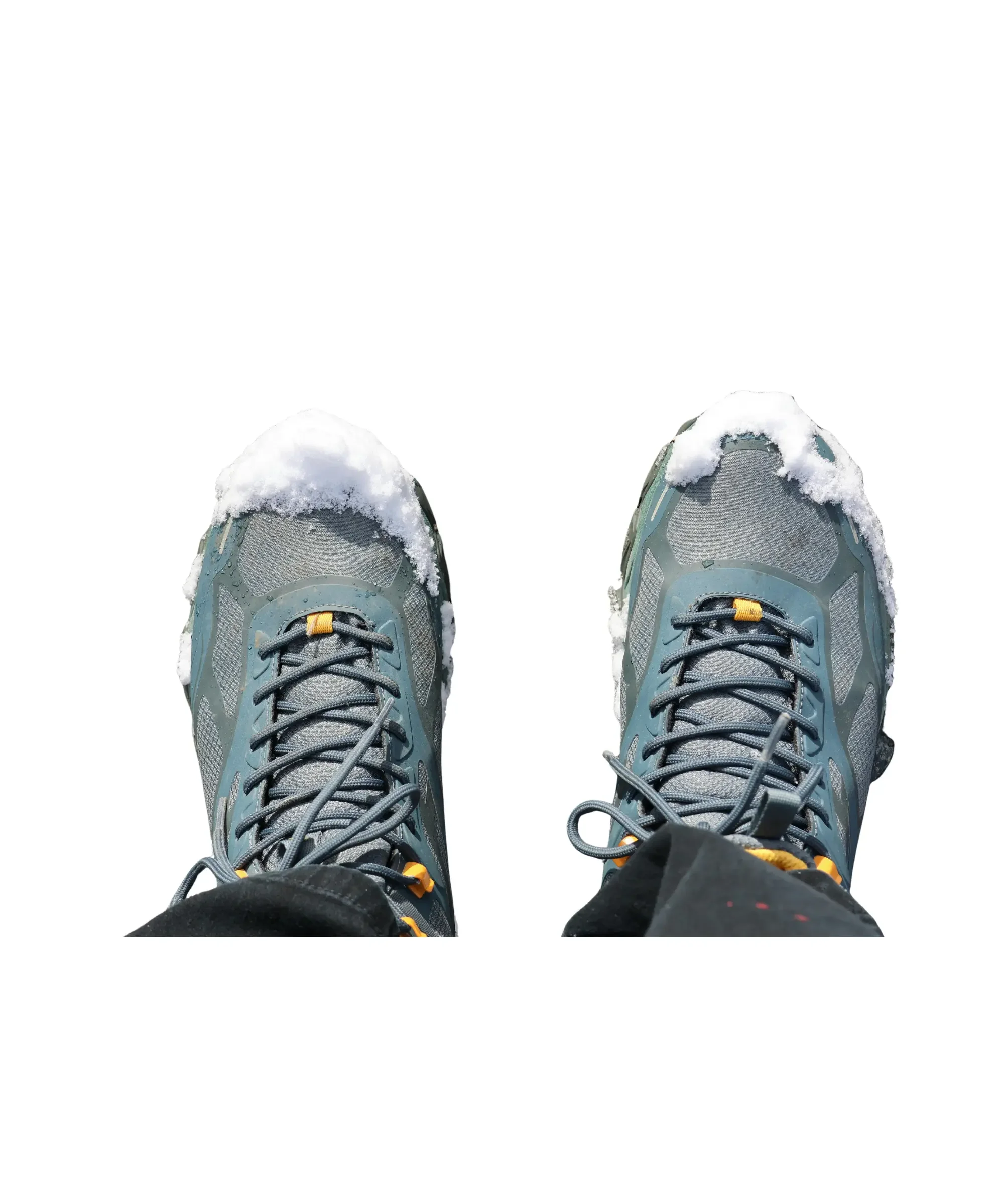 Waterproof winter shoes covered in snow, showing the importance of protecting shoes from moisture and slush