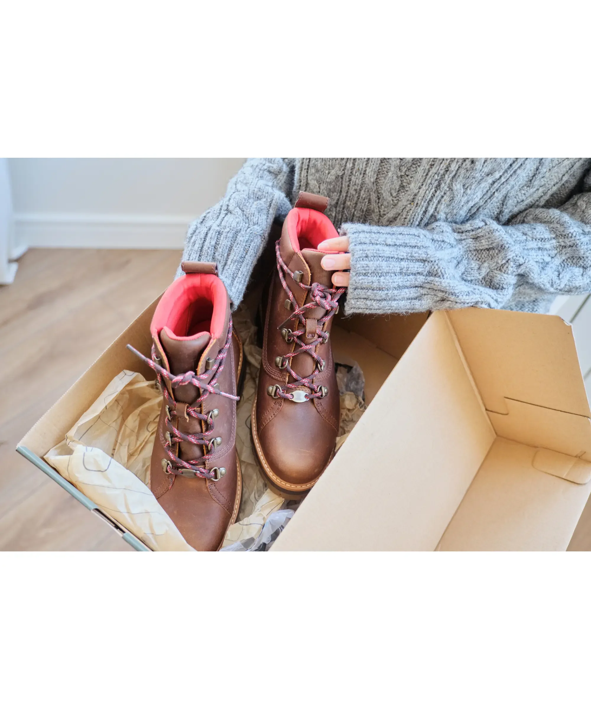 New winter boots being unpacked from a box, ideal moment to waterproof and protect winter footwear before first wear