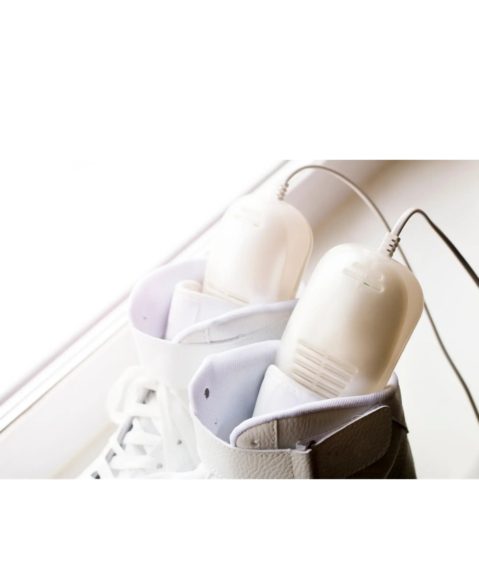 Electric boot dryer placed inside winter boots to dry moisture and prevent odor during cold weather