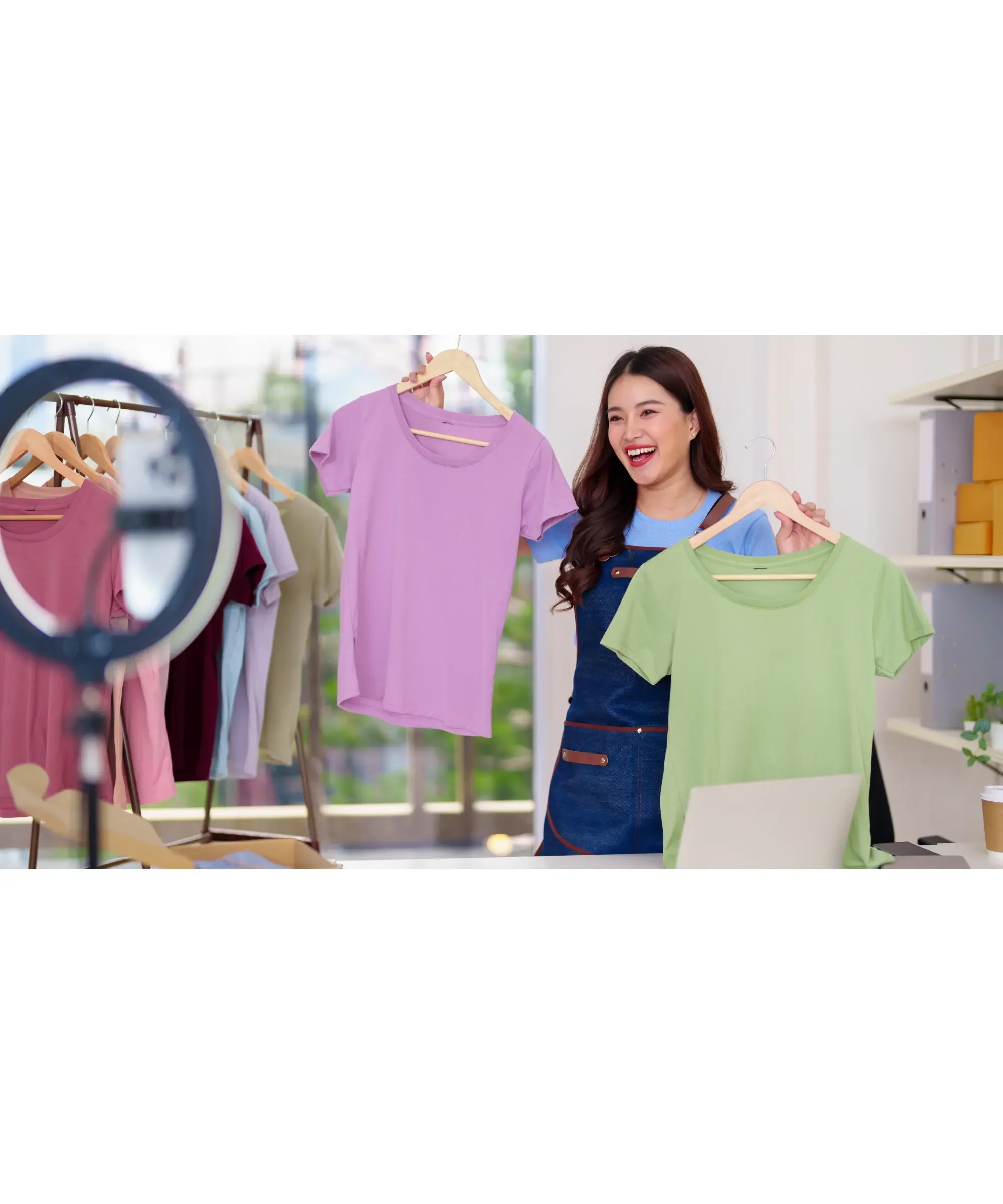 Small business owner presenting clothing products for sale online, representing testing demand before launching a product business.
