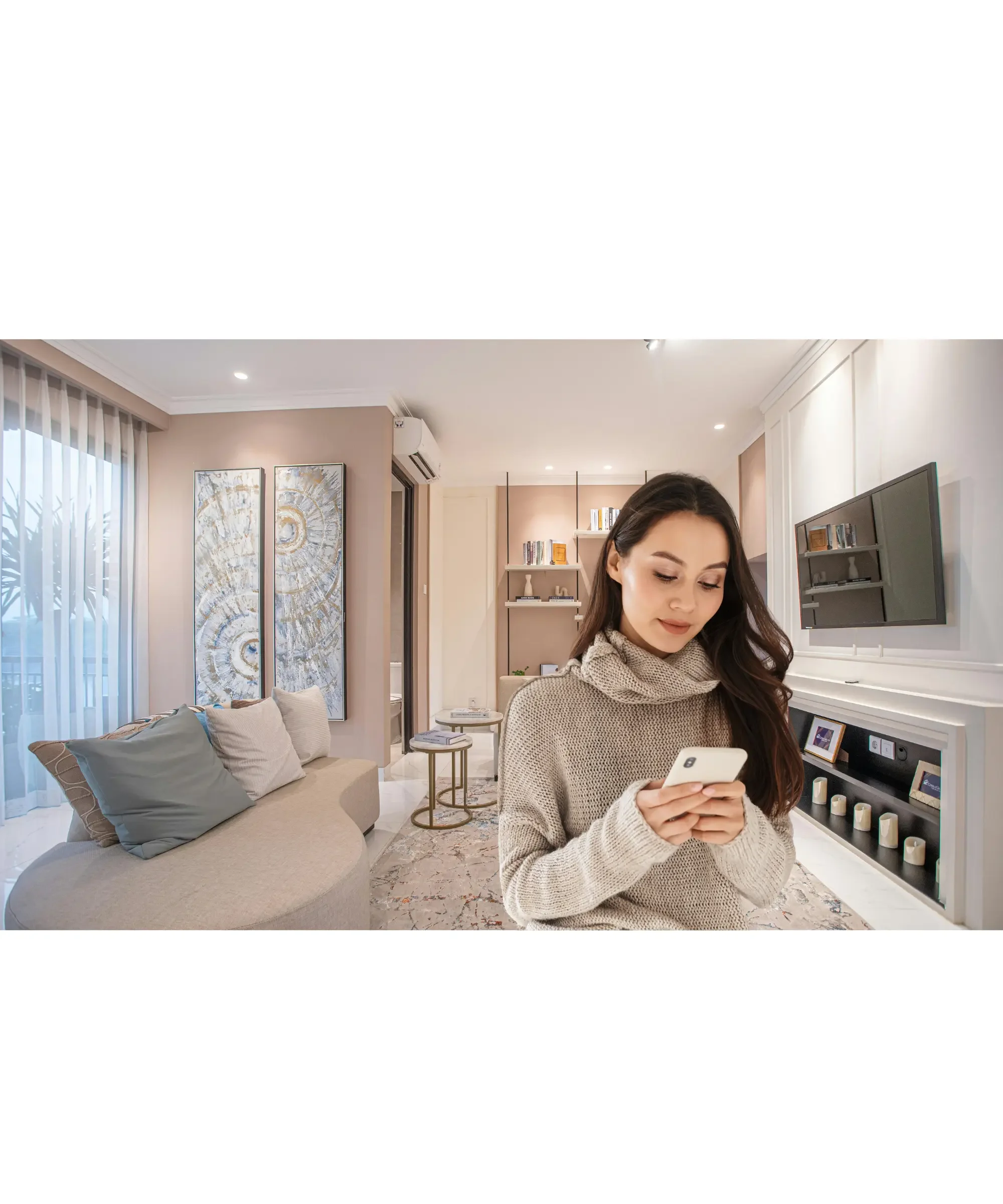 Woman controlling smart kitchen appliance from smartphone in modern home, representing smart air fryer app control and connected cooking technology.