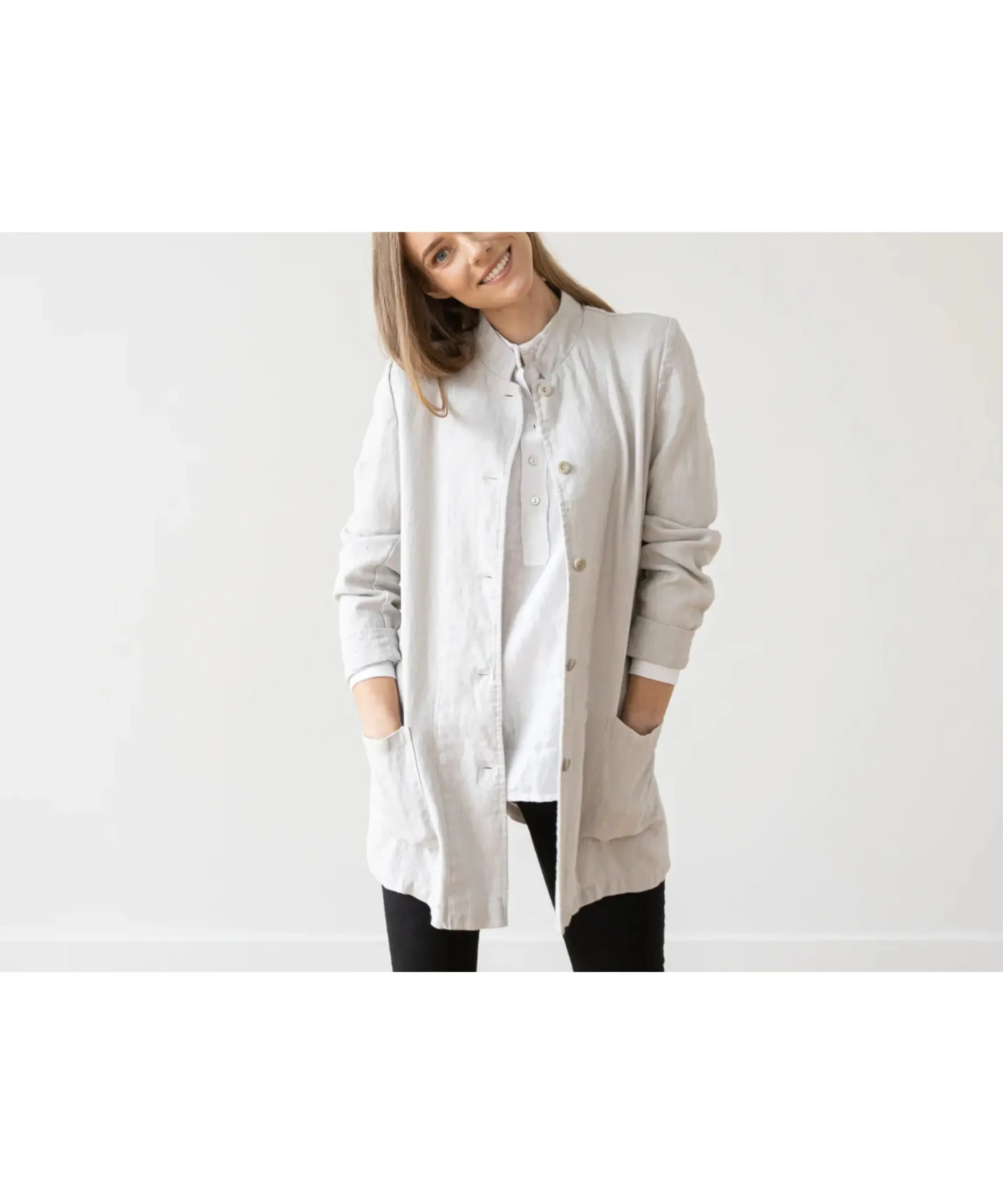 Minimal capsule wardrobe look featuring a lightweight linen blazer layered over a simple white top, paired with dark pants—an effortless, relaxed outfit that blends structure with everyday comfort.