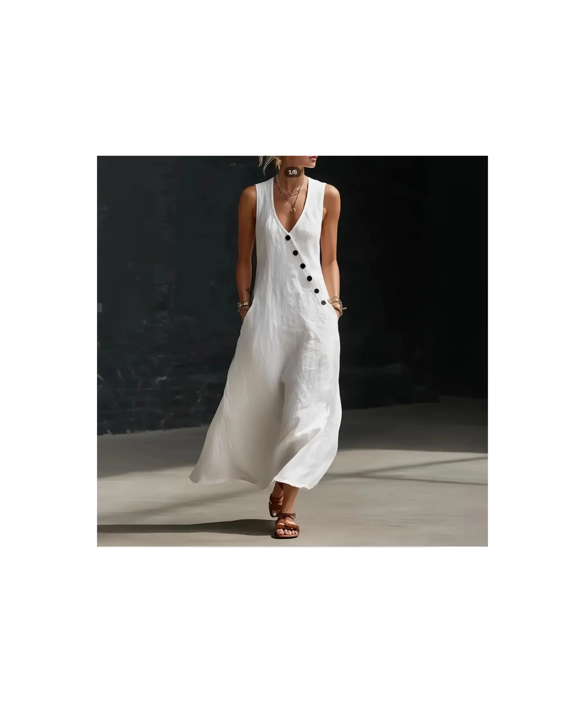 White cotton linen sleeveless dress with a relaxed flowing silhouette, featuring a V-neckline and asymmetrical button detail, styled with sandals in a minimalist, softly lit setting.