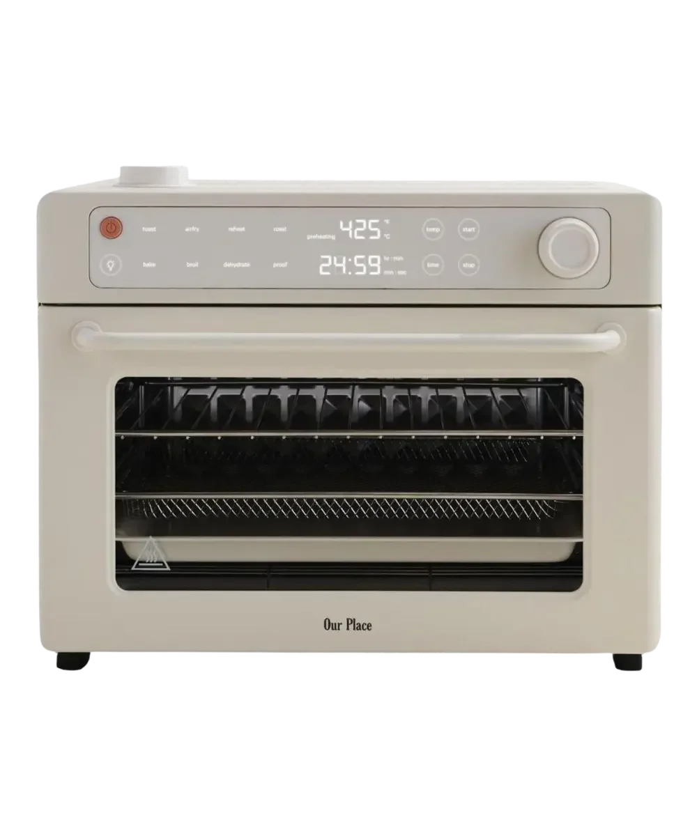 Our Place Wonder Oven Pro 8-in-1 digital air fryer and toaster oven in a warm cream color.