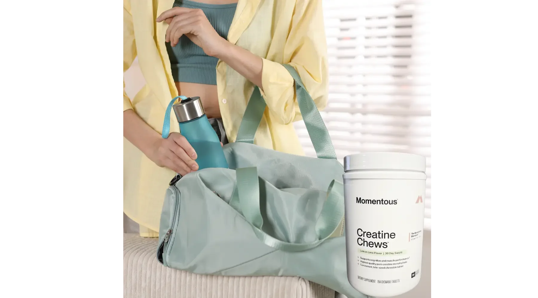 Woman packing a gym bag beside a container of Momentous Creatine Chews.