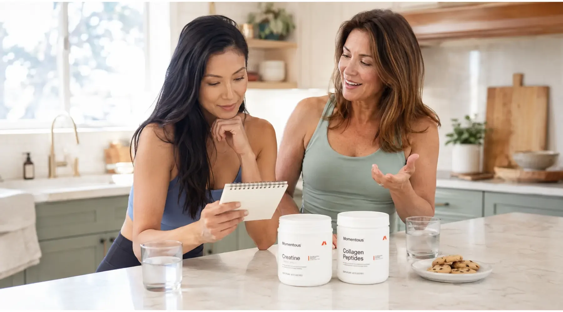 Two women tracking their progress beside Momentous Creatine and Collagen Peptides.