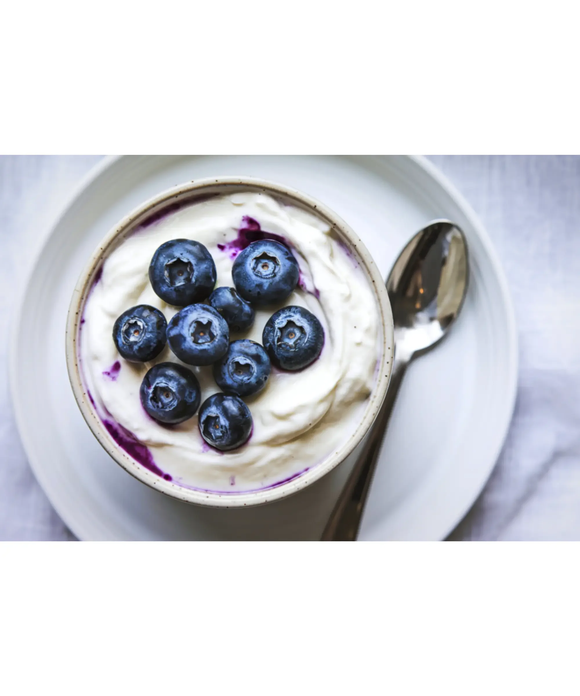 a bowl of yogurt topped with blueberries