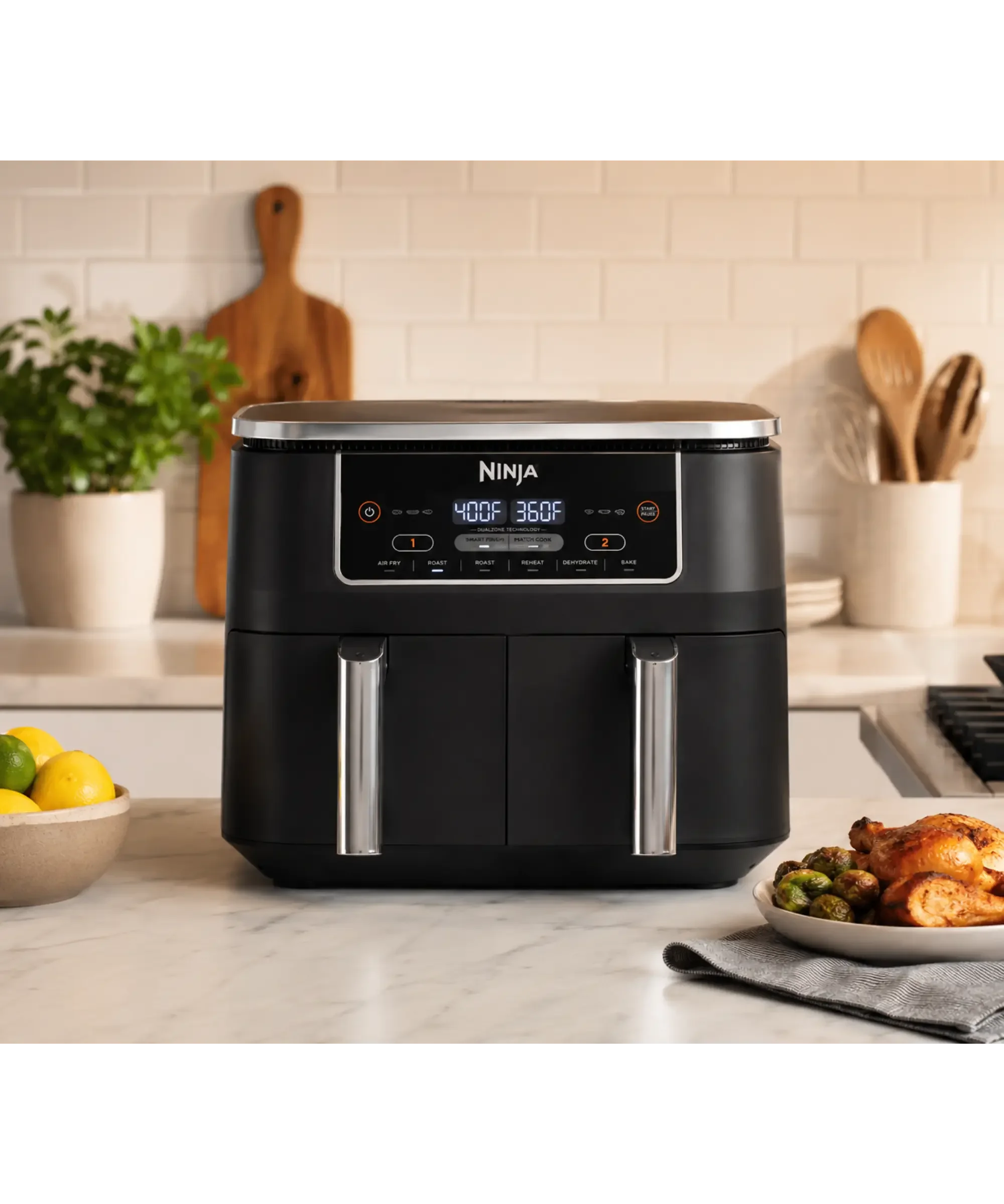 Black Ninja DualZone air fryer with two independent cooking baskets displayed on a bright marble countertop in a modern kitchen, surrounded by fresh ingredients and ready for healthy home cooking.