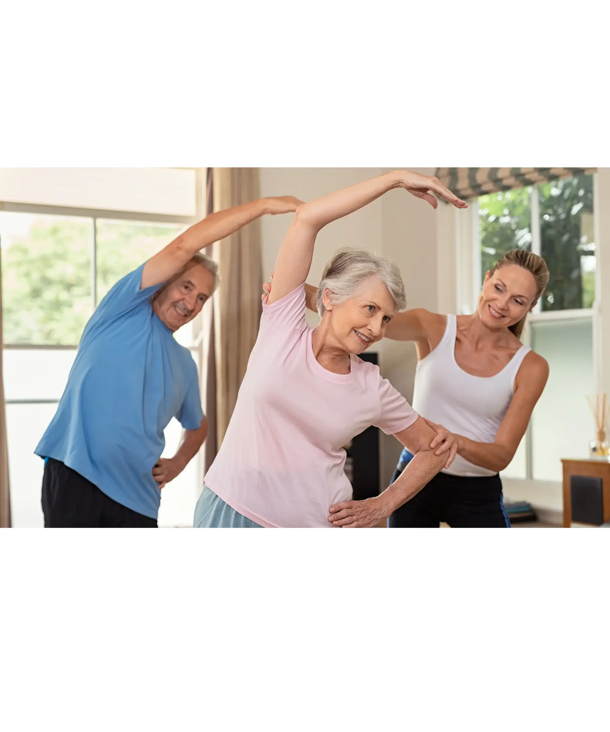 Older adults stretching together with guidance from an instructor in a bright living room