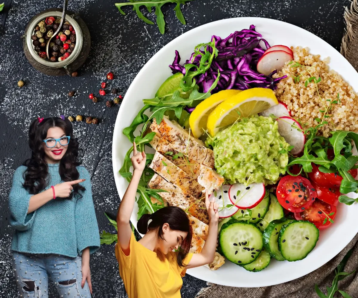 Two women beside a balanced meal with grilled chicken, quinoa, avocado, and colorful vegetables.