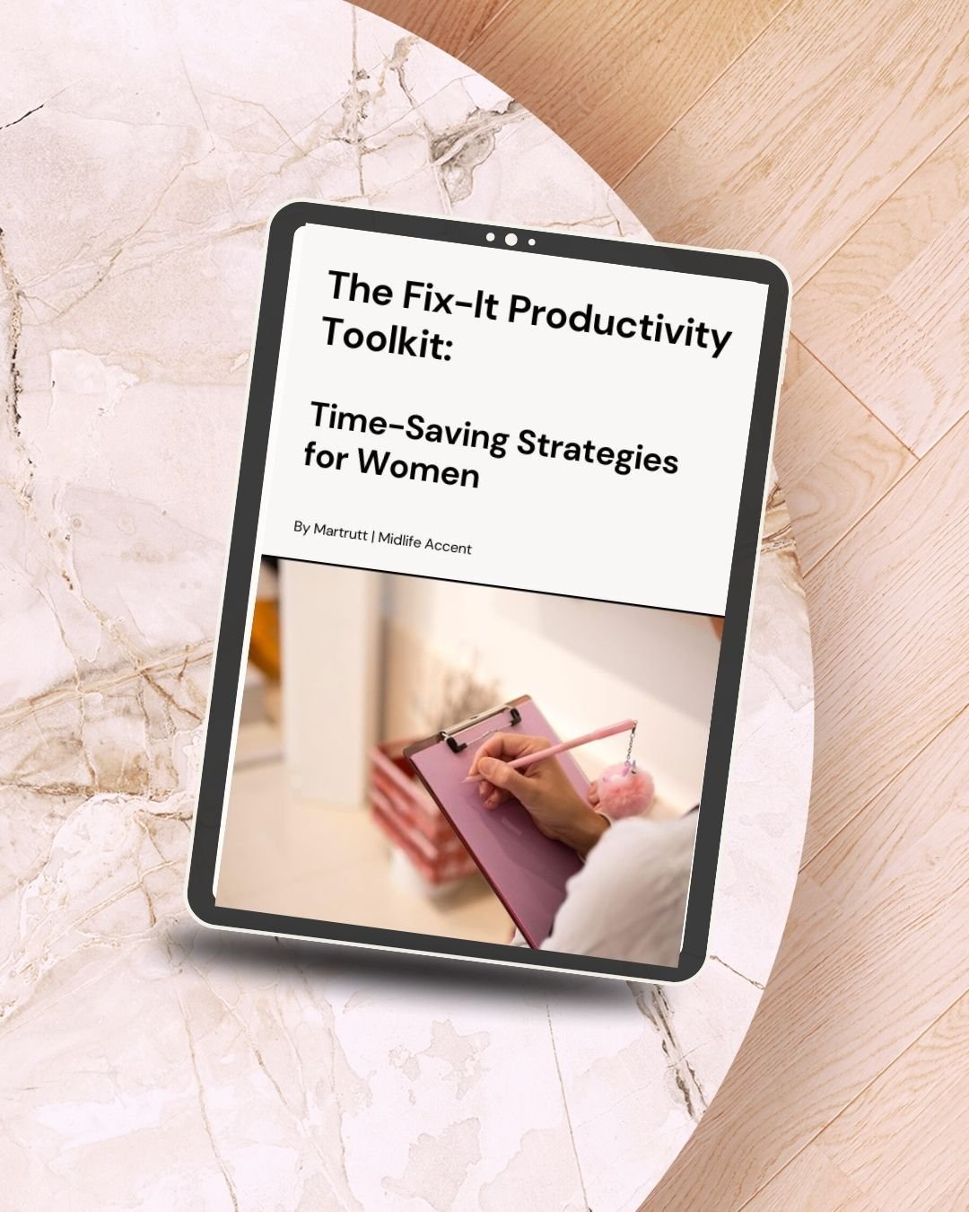 Mockup of an iPad displaying the cover of 'The Fix-It Productivity Toolkit: Time-Saving Strategies for Women' by Martrutt, placed on a marble table."