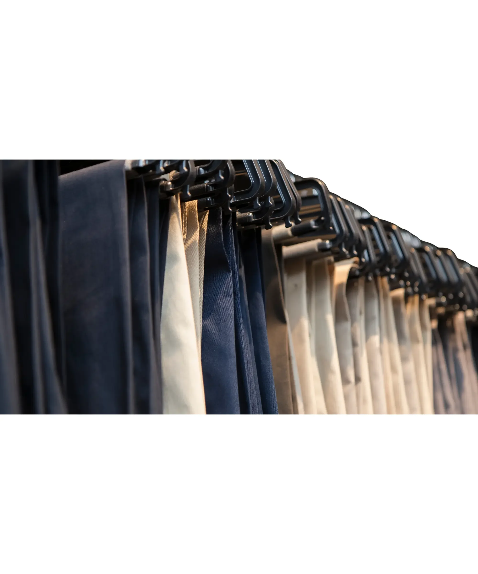 Neutral-colored winter leggings hanging on a clothing rack.
