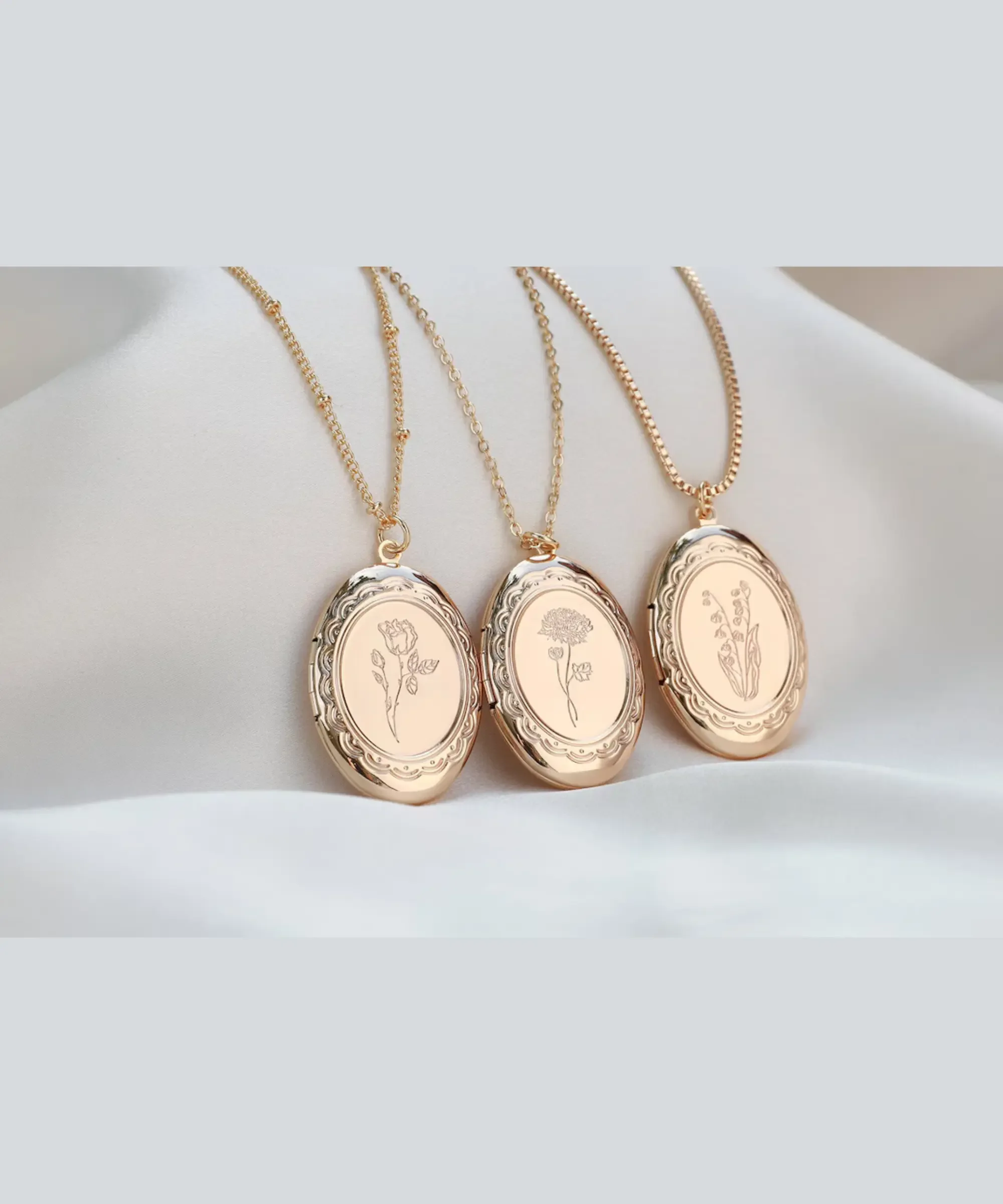 Gold birth flower locket necklace with engraved floral design.