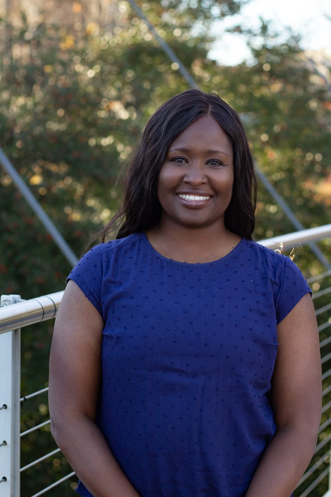 Angela, Functional Pharmacist at ROOT Wellness Hub, smiling in a professional headshot.