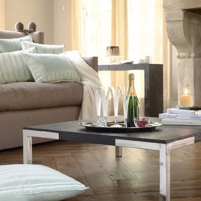 Living room with couch, coffee table, and decorative items, including a candle.