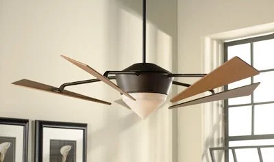 Modern ceiling fan with wooden blades and integrated light in a well-lit room.